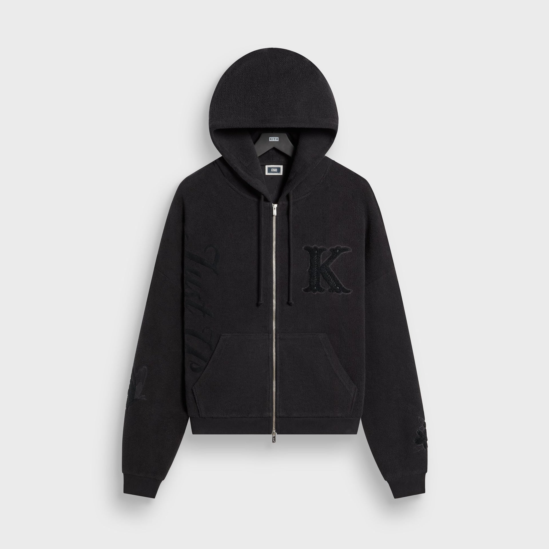 Kith Varsity Braxton hoodie in black fleece with chenille K patch, front flat lay