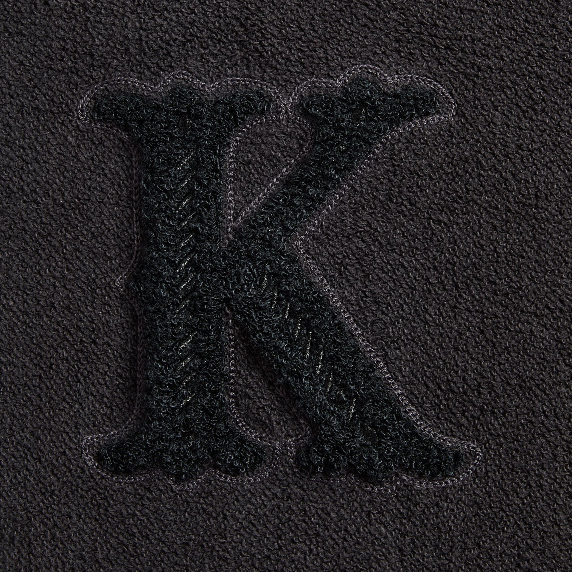 Close-up of the chenille K patch on the Kith Varsity Braxton hoodie