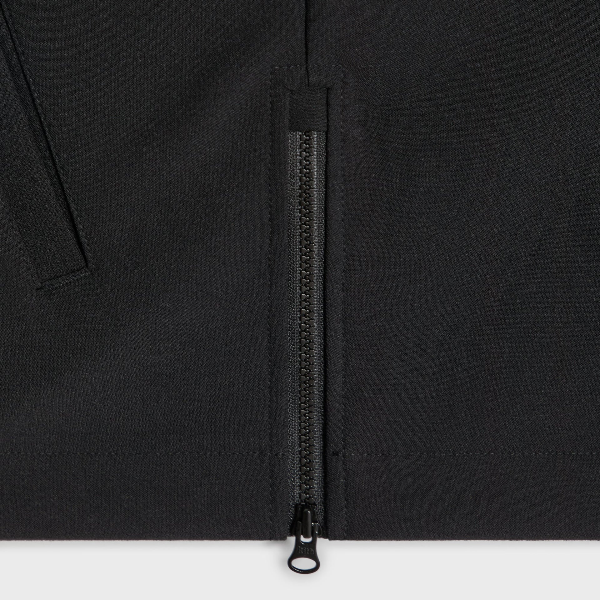 Close-up of the quarter zip and side seam on the Kith Davis pullover in black