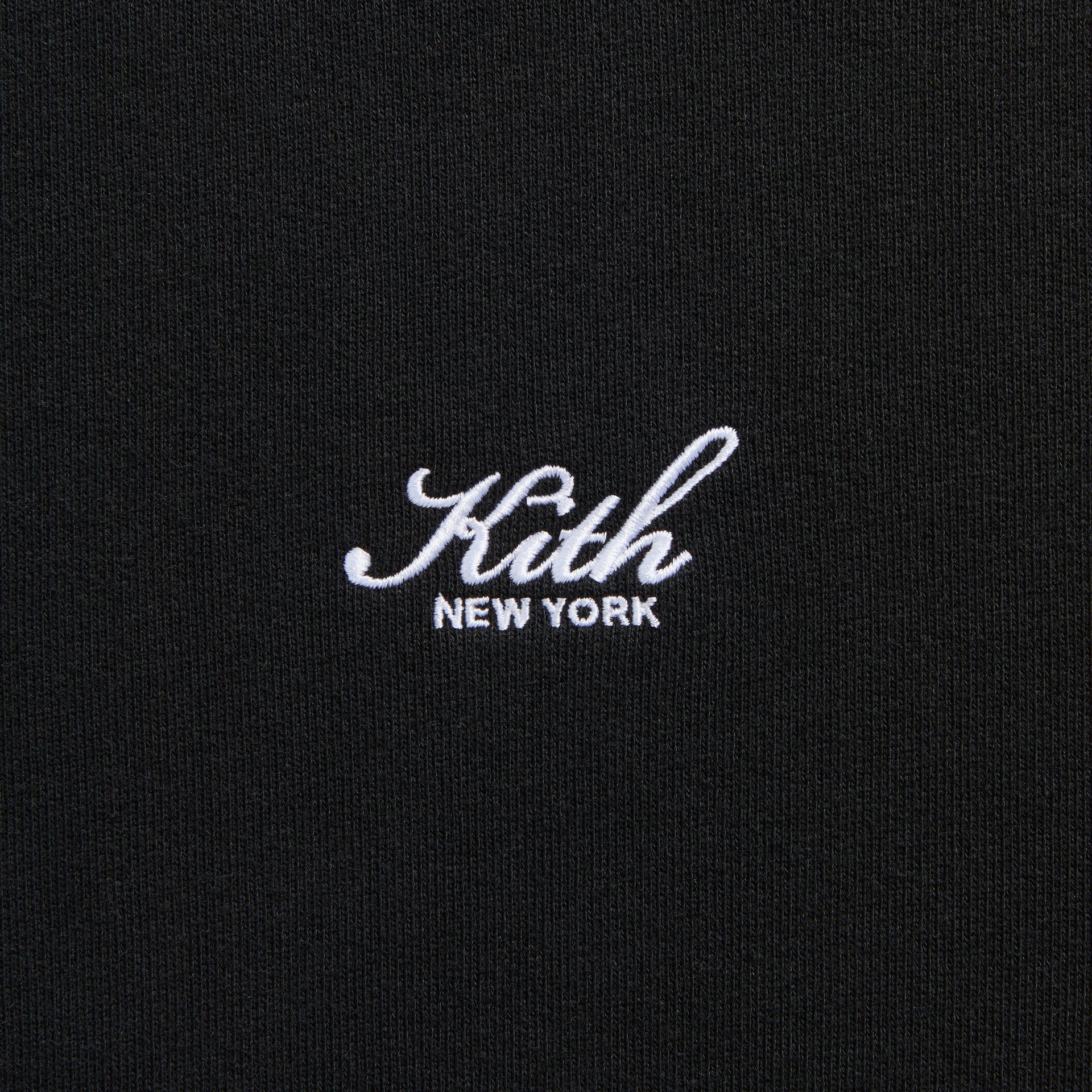 Close-up of the embroidered Kith New York script logo on the Nelson crewneck in black