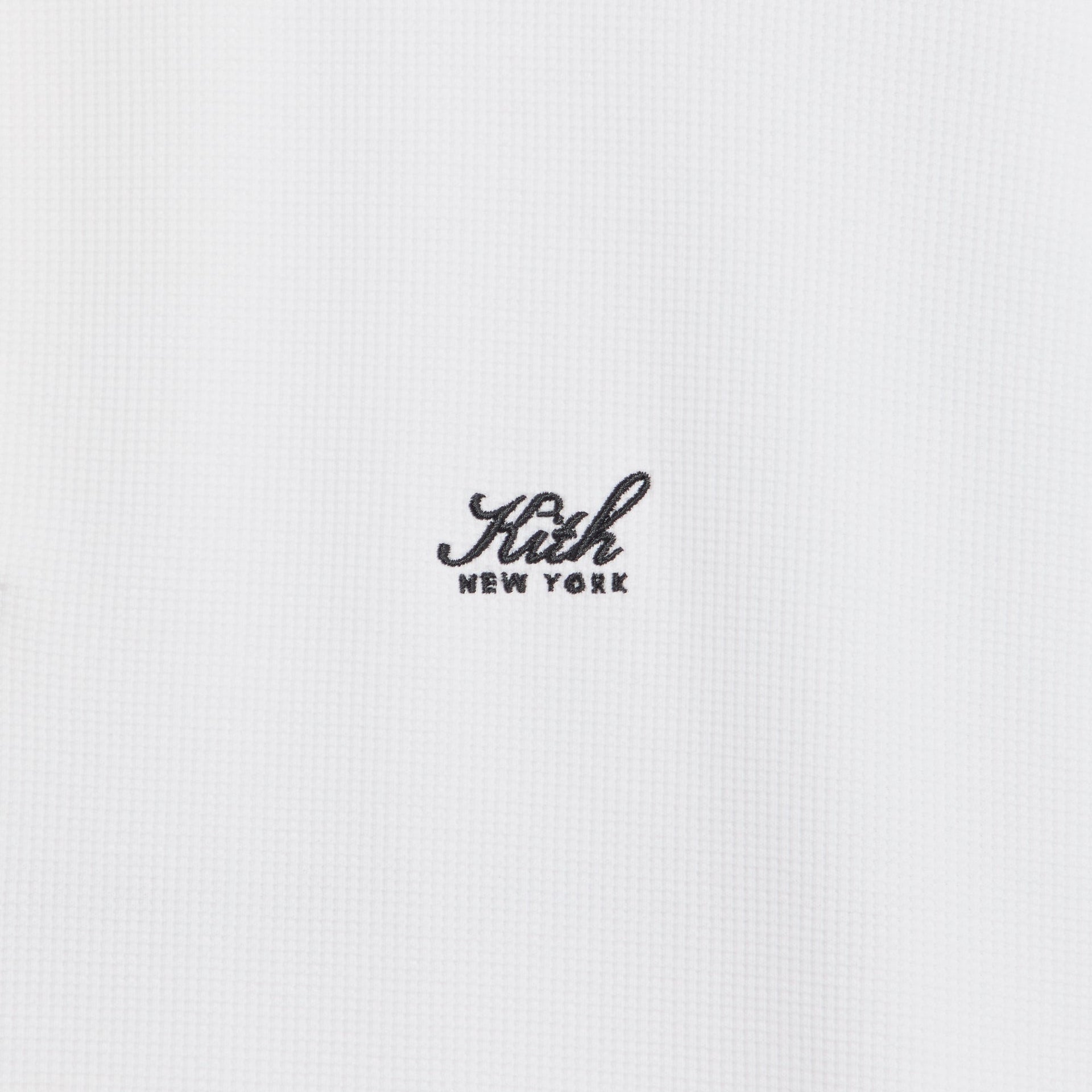 Close-up of the embroidered Kith New York script logo on the Colby pullover in white