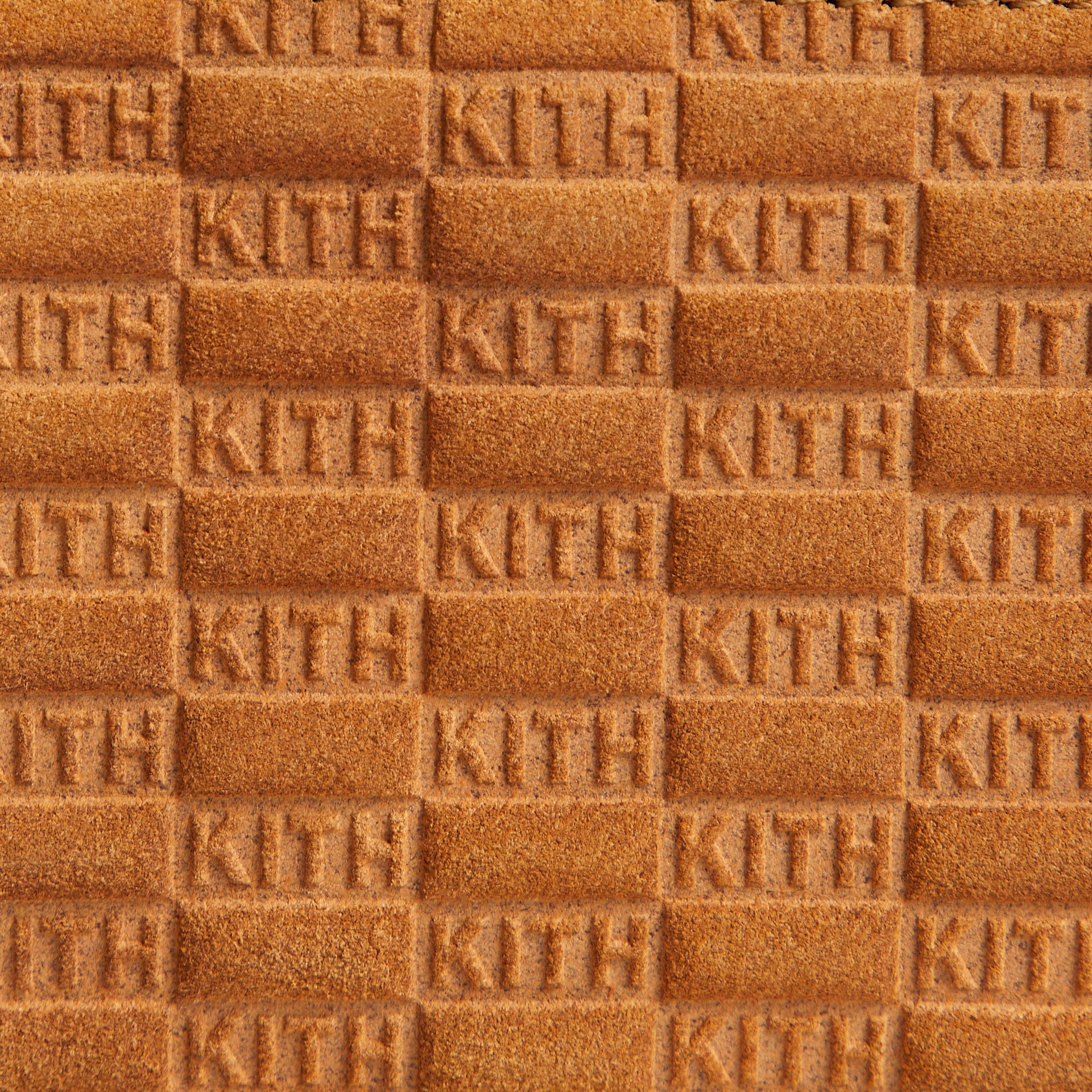 Close-up macro detail of embossed KITH monogram suede texture on Crosswalk K20 Bag