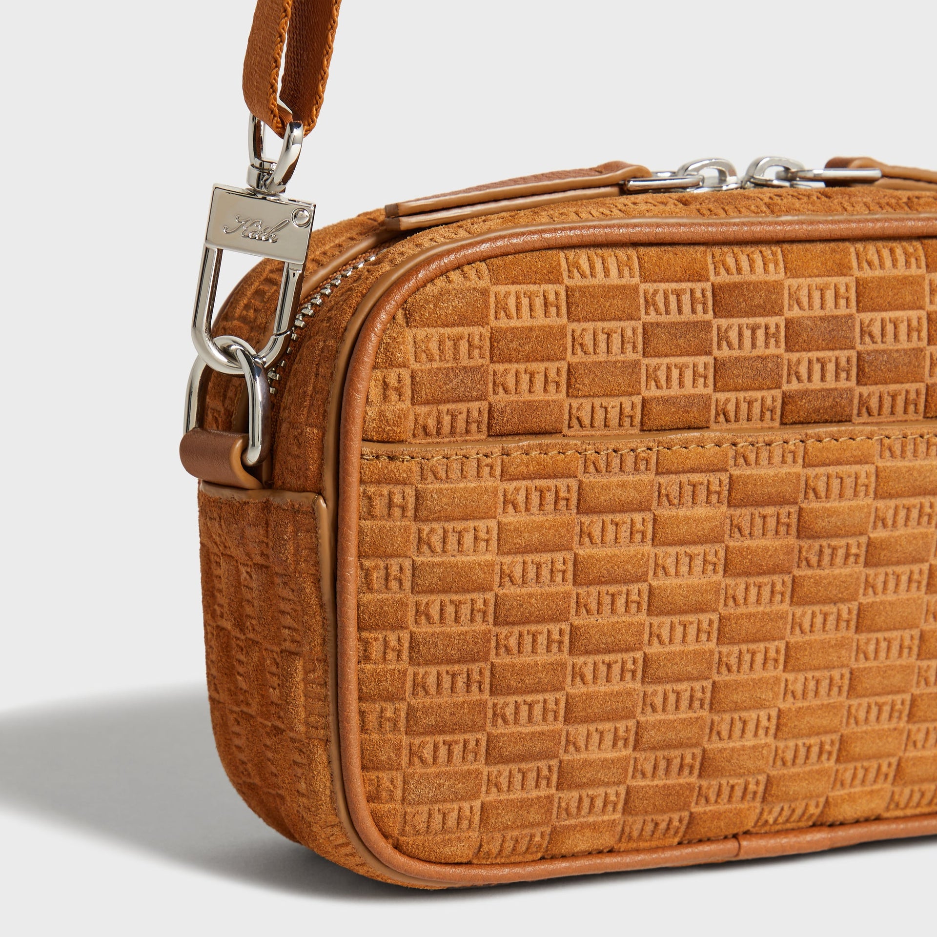 Close-up of corner strap clip and Kith logo charm on Crosswalk K20 Bag in Argil suede
