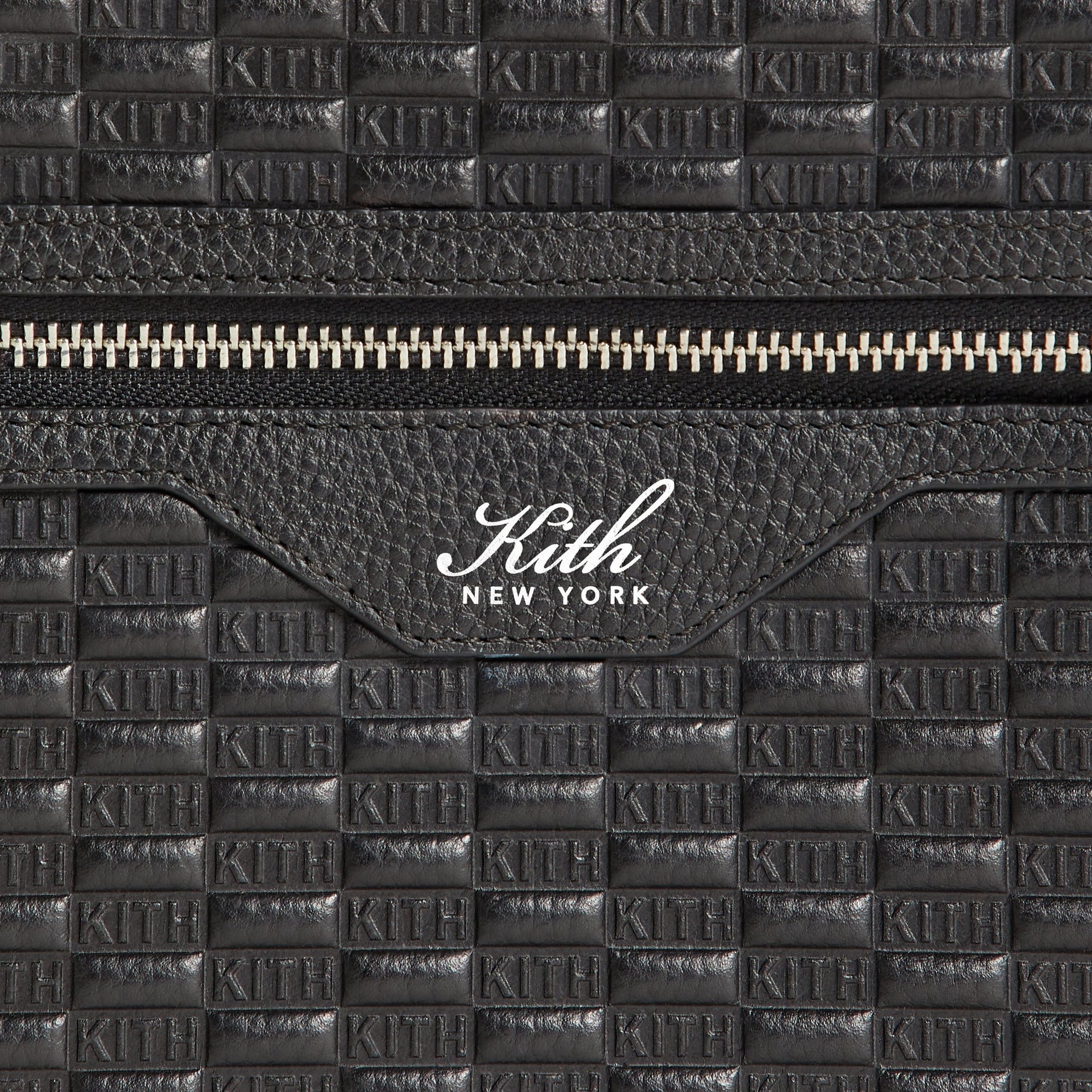 Close-up of front zip pocket with Kith New York logo tab on Camera Crossbody Bag in Black