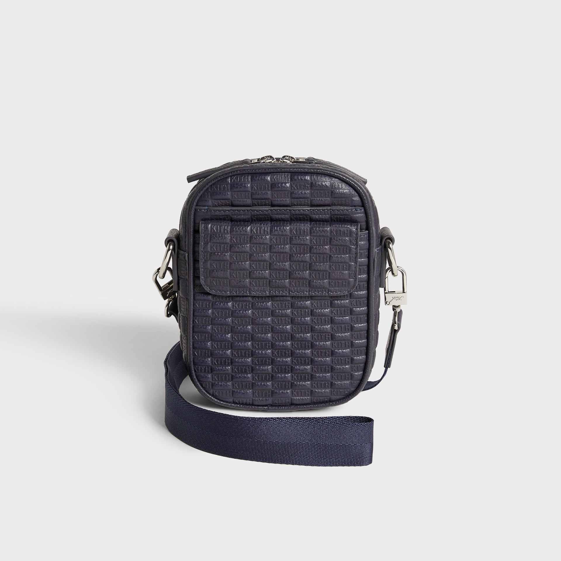 Kith Monogram Tumbled Leather Passenger K15 Bag in Ink, front three-quarter view with crossbody strap