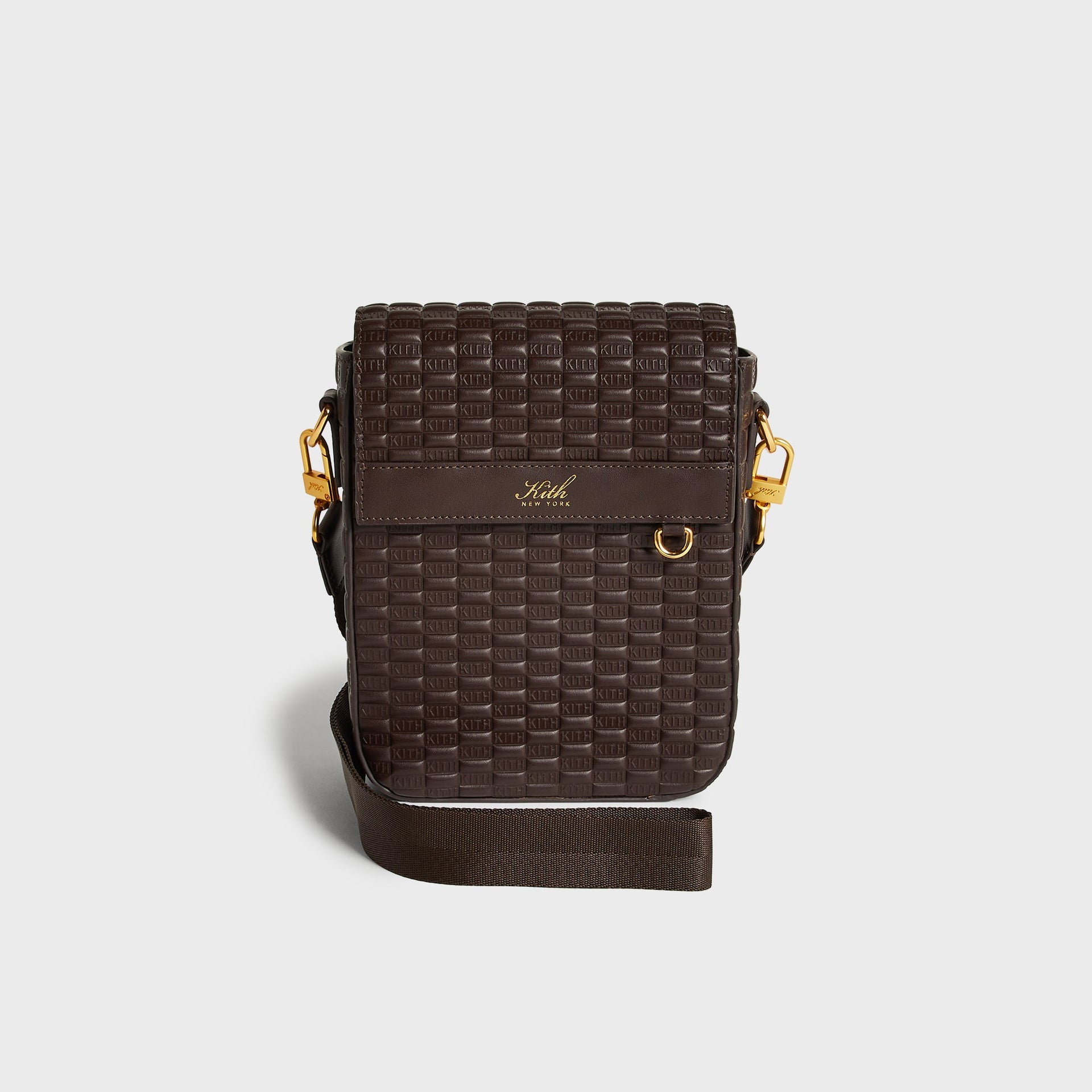 Kith Monogram Smooth Leather Explorer Pack in brown, front view showing embossed KITH monogram leather, gold hardware, and Kith New York logo patch