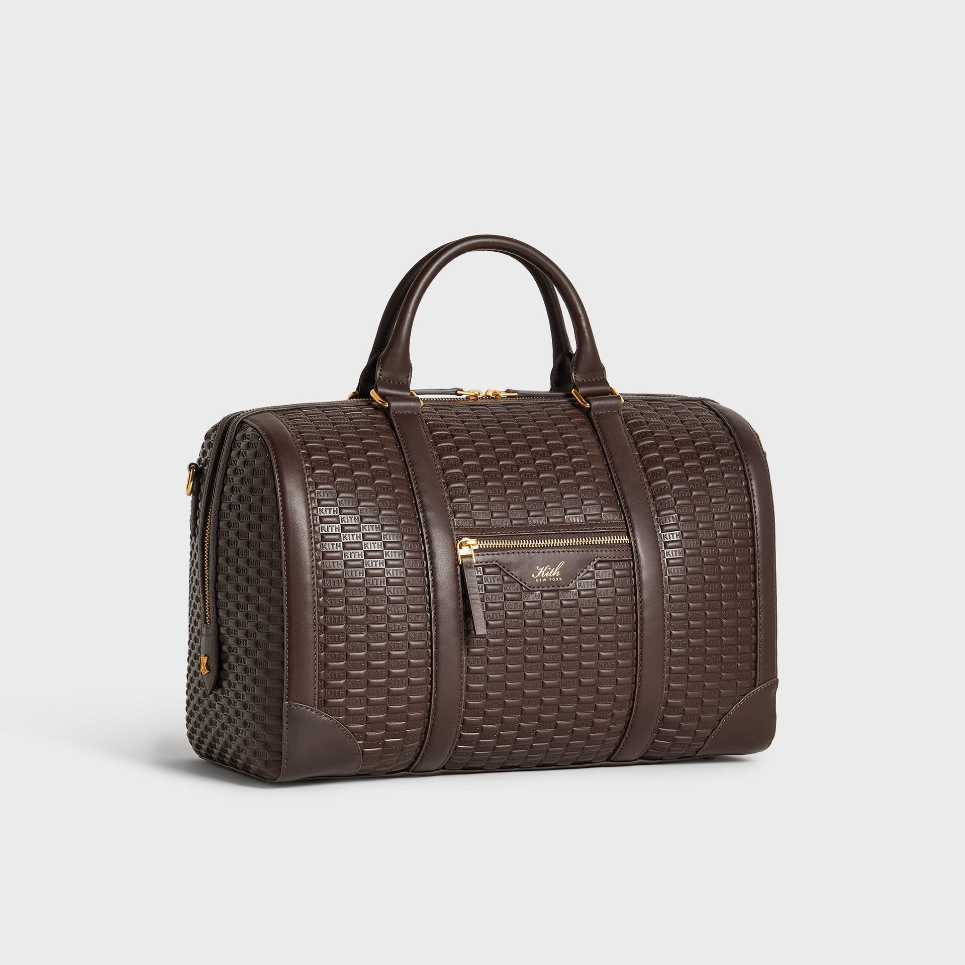 Three-quarter angle view of the Kith Traveler K40 Duffle Bag in Zoom brown embossed leather