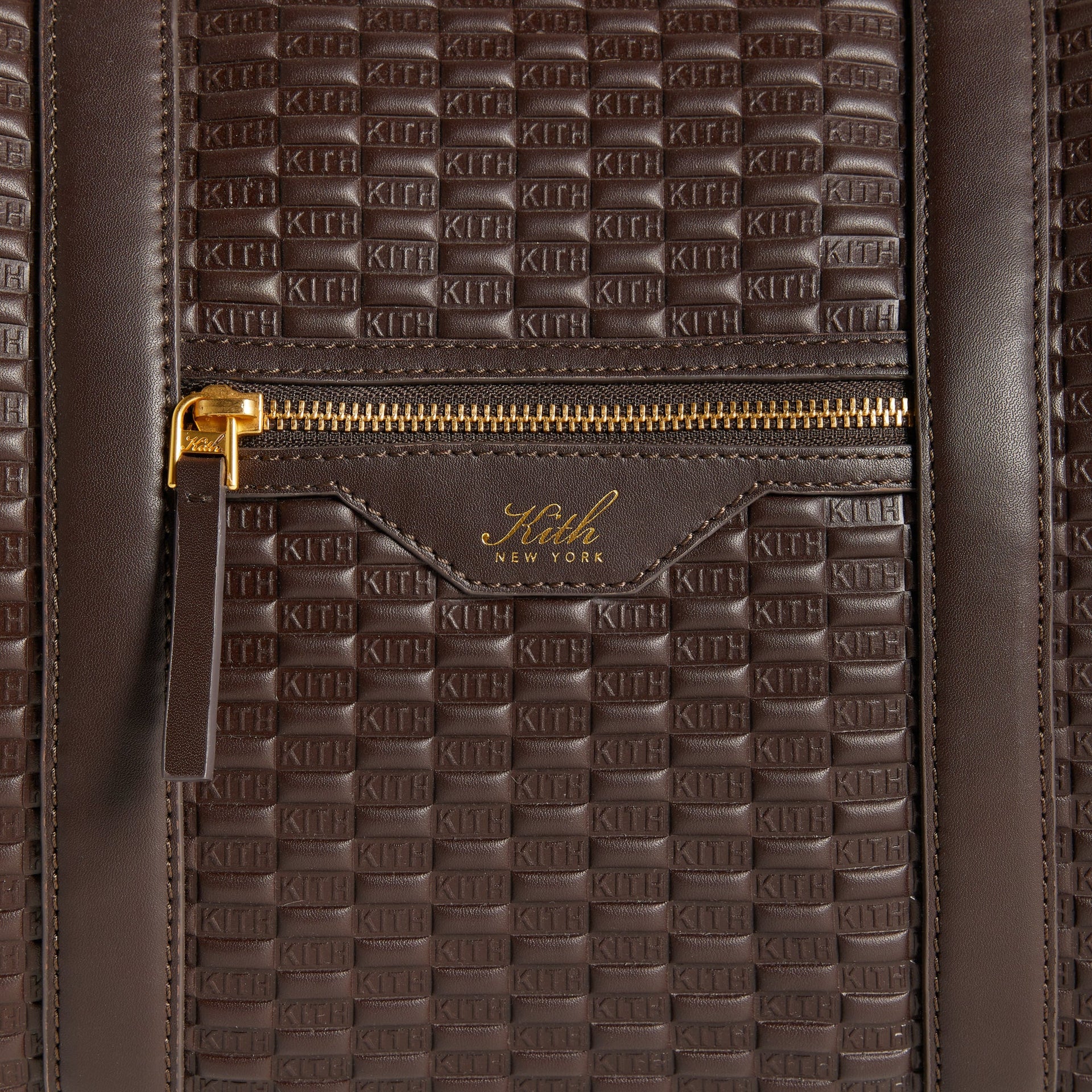 Close-up of front zip pocket with gold-foil Kith New York logo on the Traveler K40 Duffle Bag