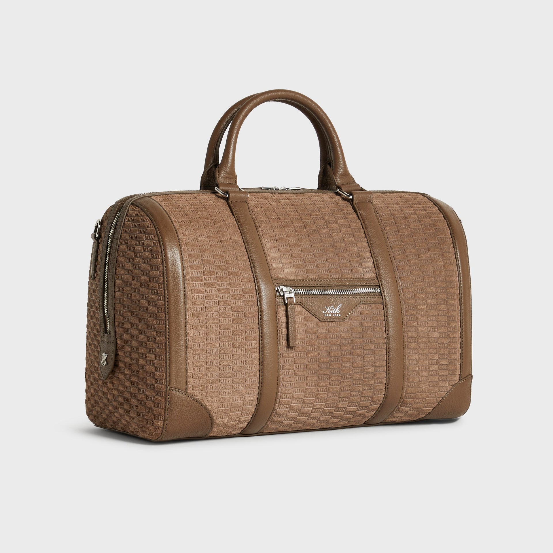 Kith Monogram Suede Traveler K40 Duffle Bag in Java, angled 3/4 view with shoulder strap draped over front