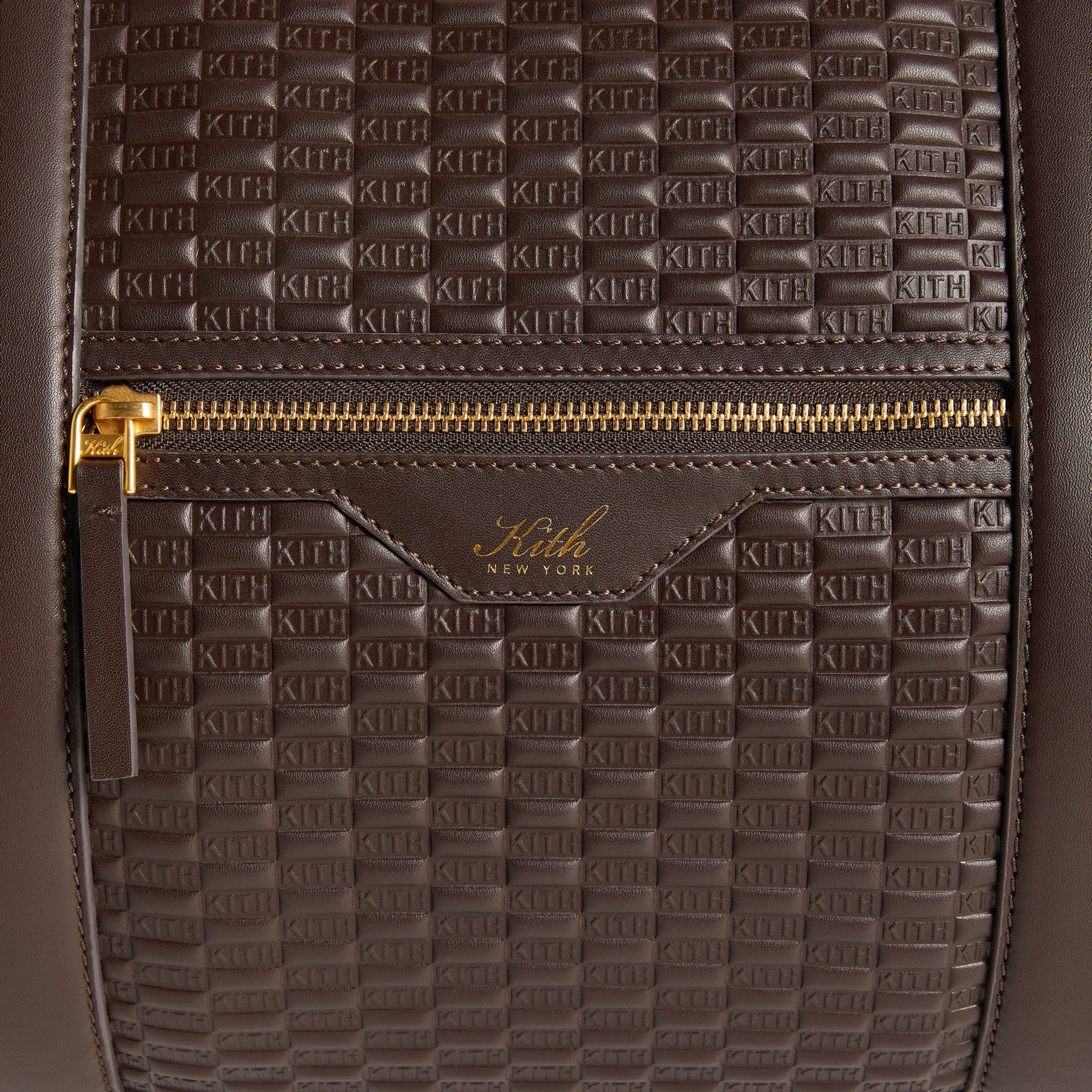 Close-up of front zip pocket with gold-foil Kith New York logo on the Traveler K55 Duffle Bag