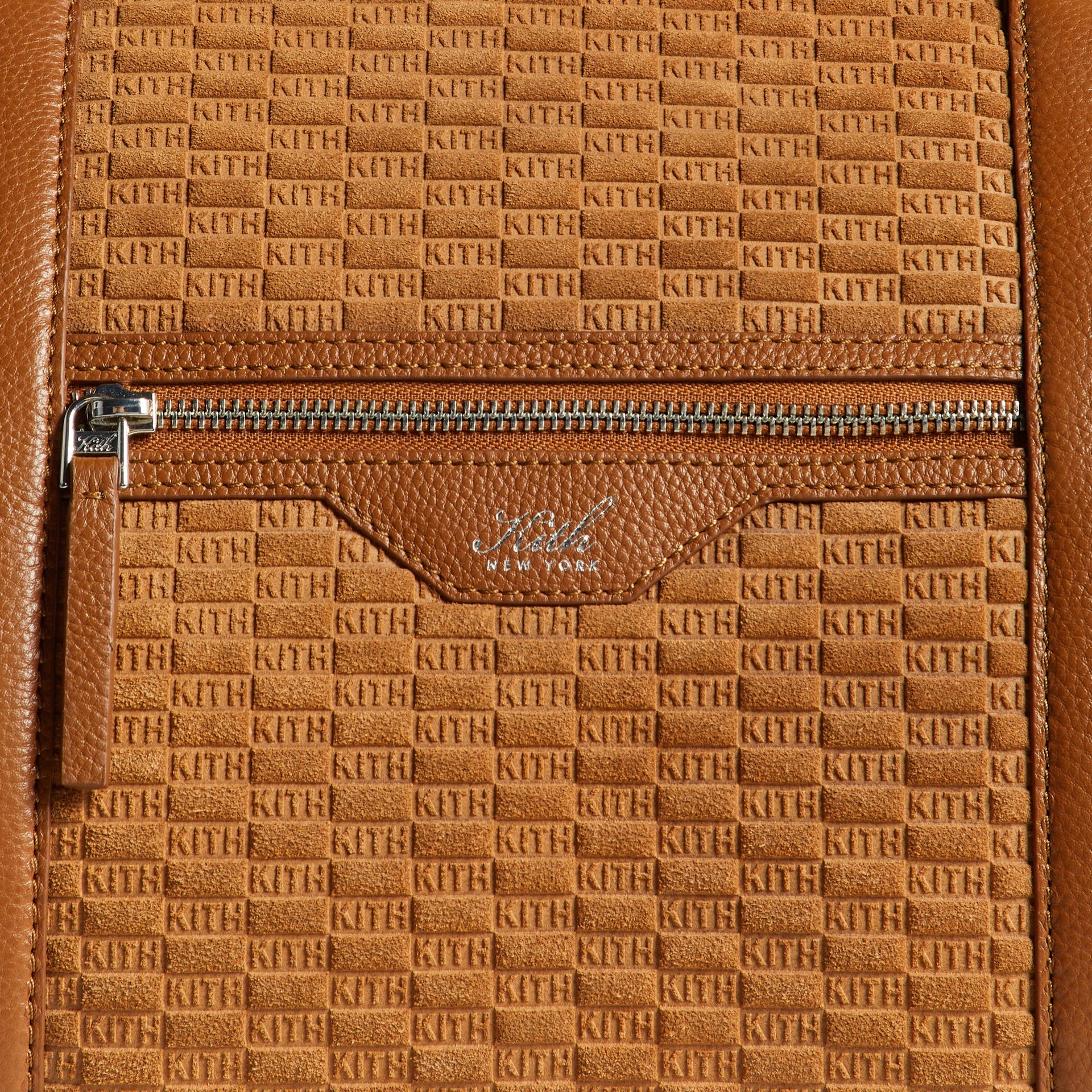 Close-up of front zip pocket with Kith New York logo tab on Traveler K55 Duffle Bag