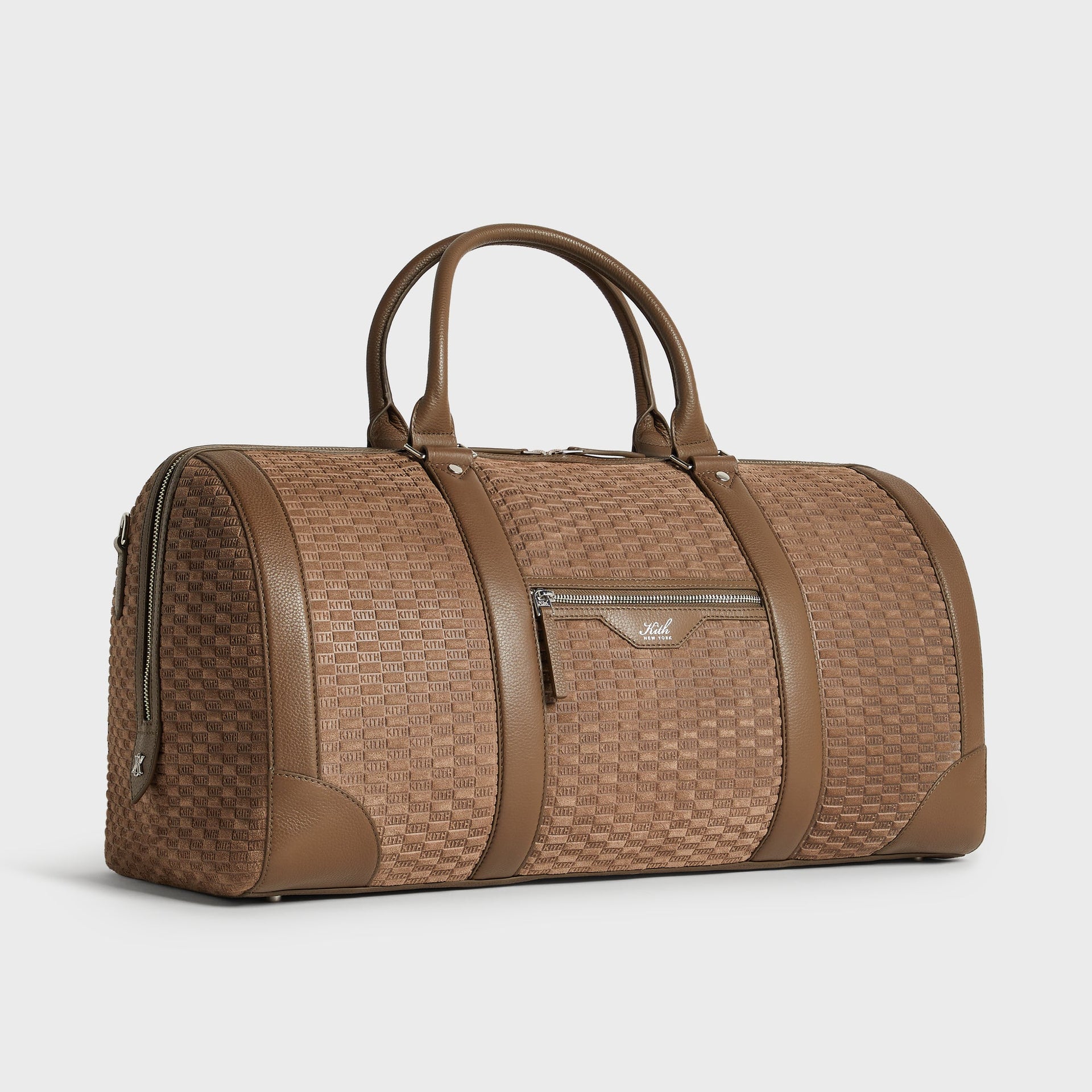 Three-quarter angle view of the Kith Suede Traveler K55 Duffle Bag in Java brown embossed suede