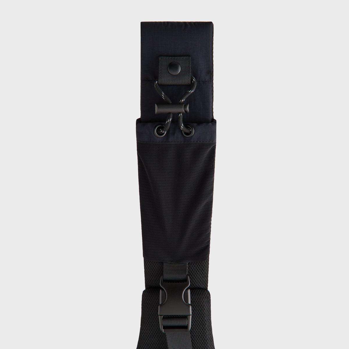Close-up of the top strap attachment with drawcord toggle and buckle on the Sling Backpack
