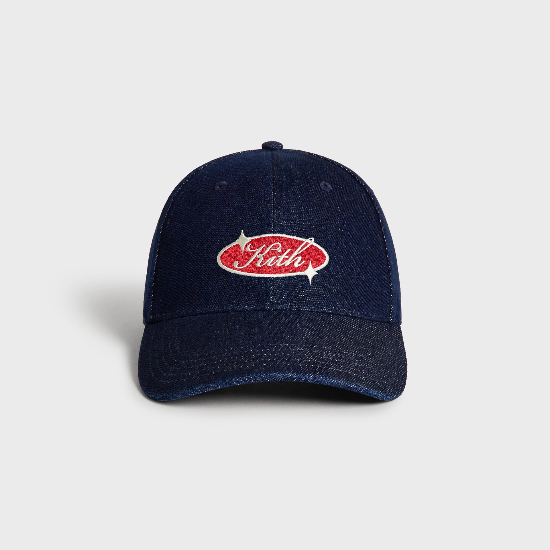 Kith Raw Denim Classic Cap in Savin Wash, front view showing red and cream oval Kith logo patch on navy denim