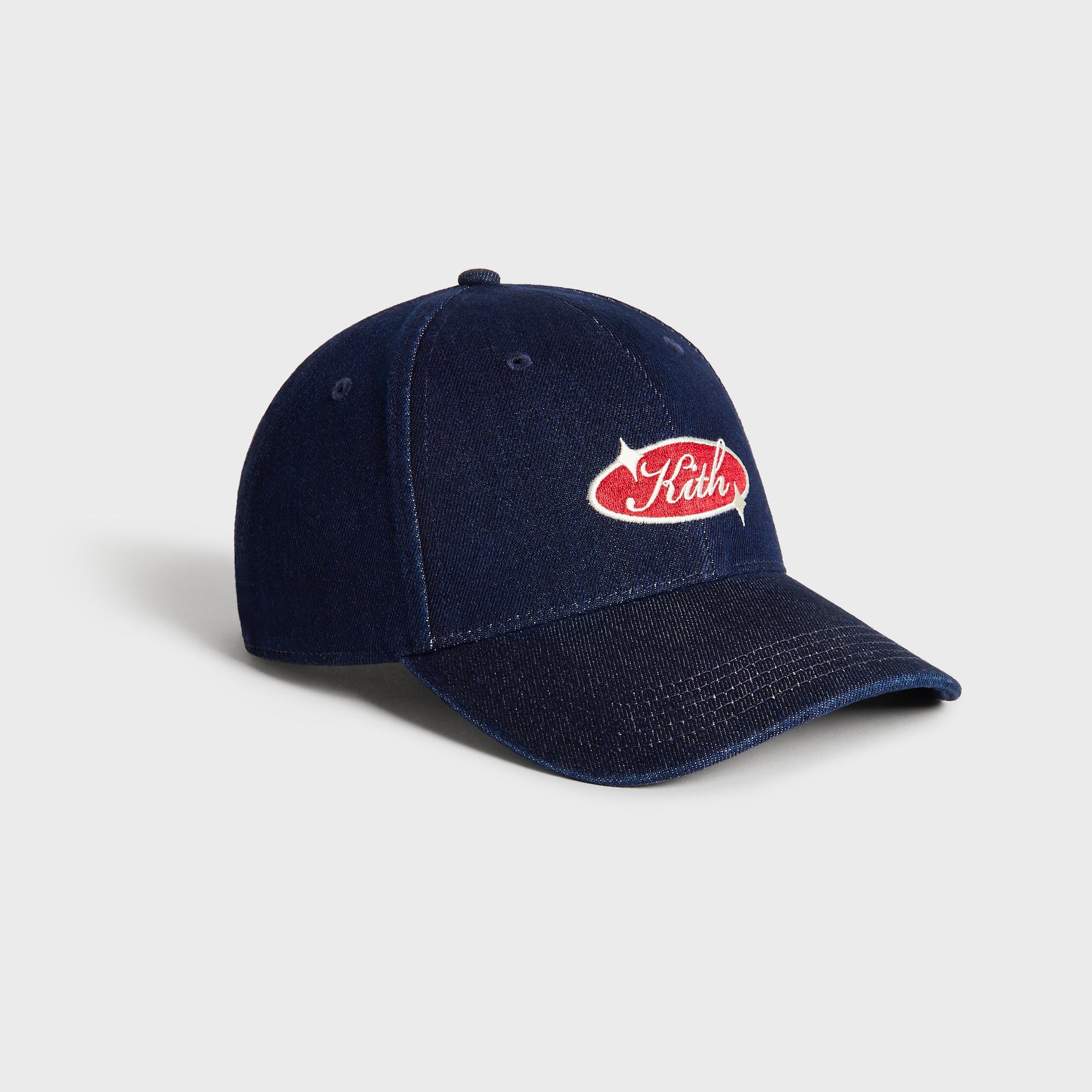 Kith Raw Denim Classic Cap in Savin Wash, three-quarter angle view of the denim crown and curved brim