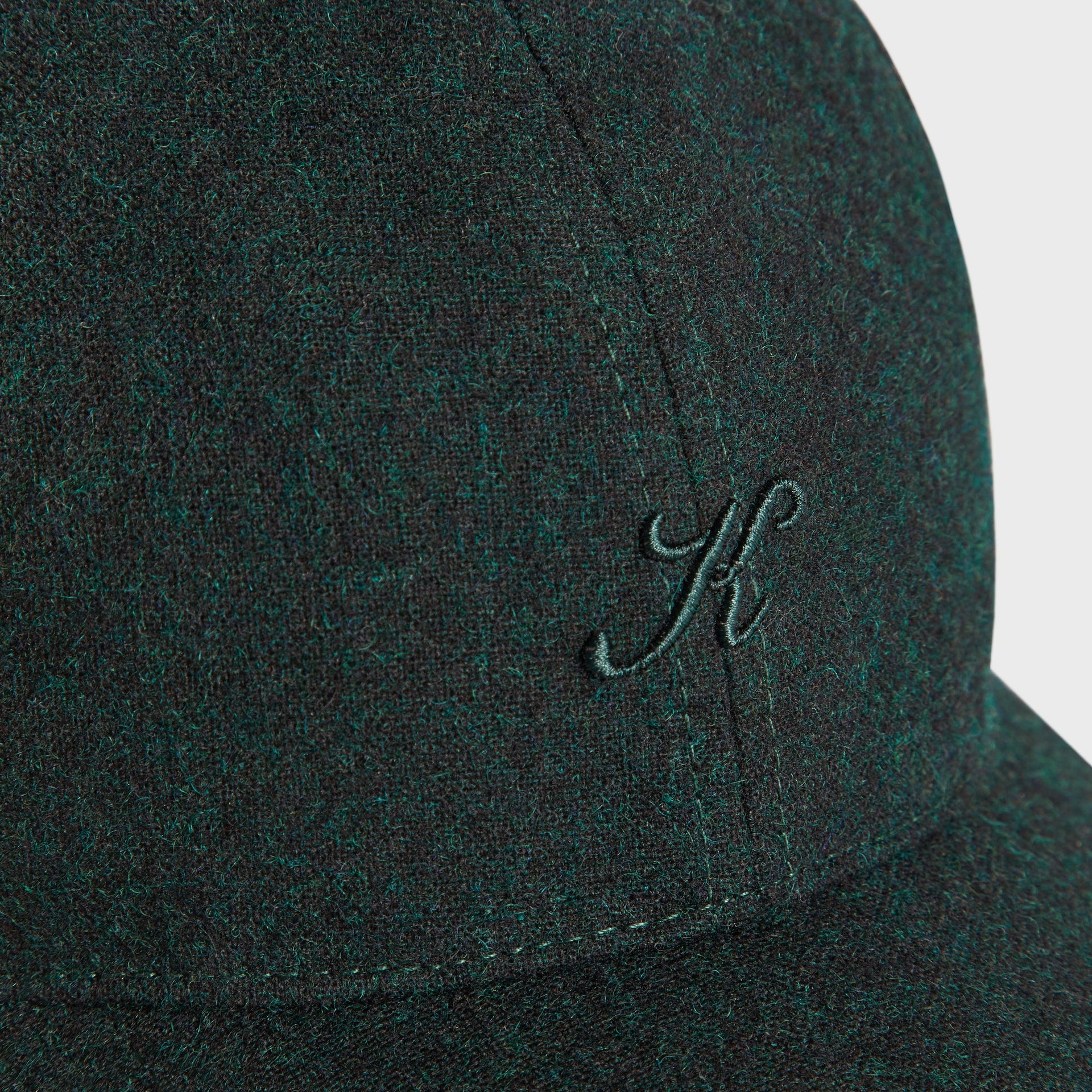 Kith Low Profile Fine Wool Classic Cap in Stadium, macro detail of the teal K script logo on heathered wool