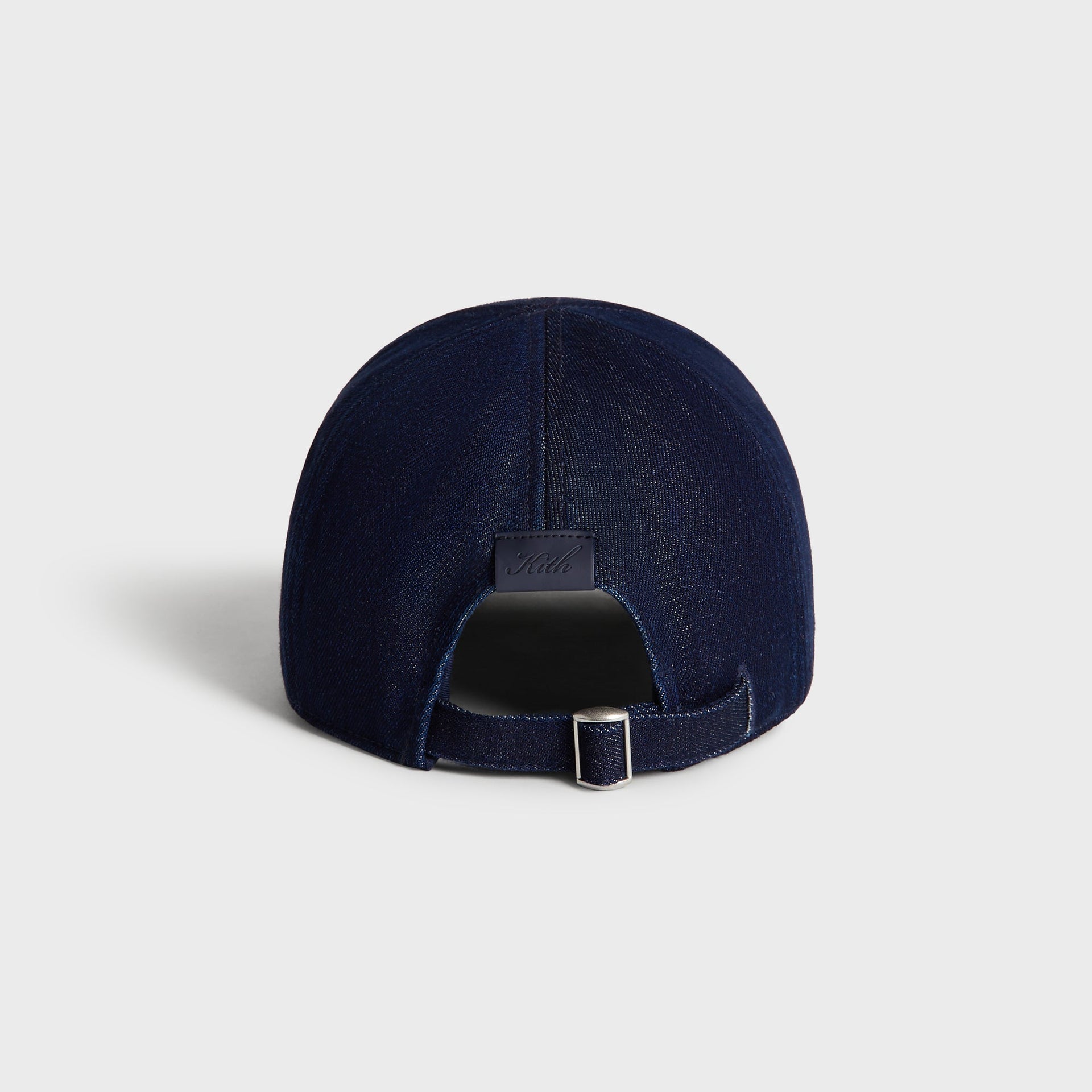 Back view of the Kith Low Profile Raw Denim Classic Cap in Savin Wash, showing the adjustable strap with metal slide buckle and leather Kith patch