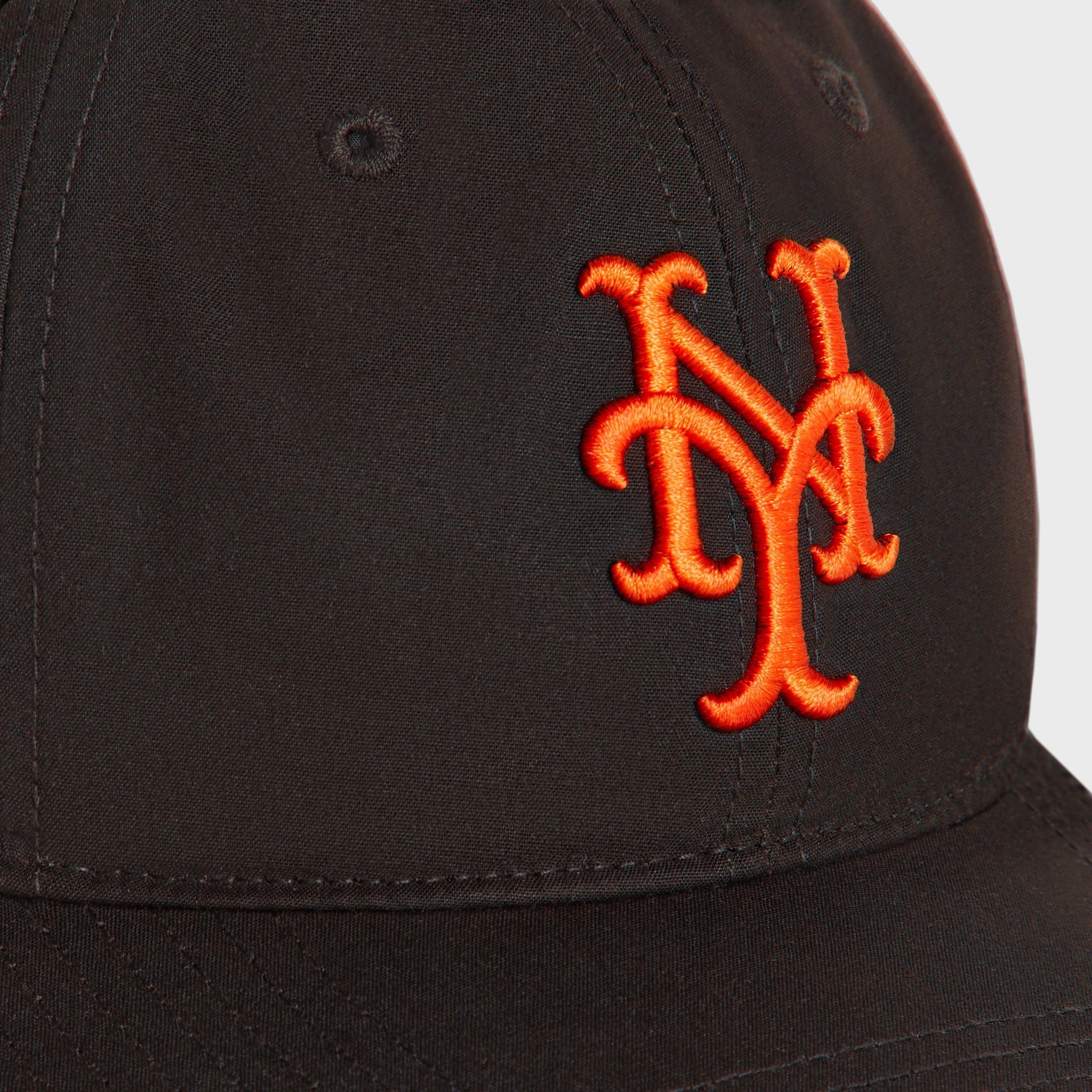 Close-up of the embroidered orange NY Mets logo on kindling brown waxed cotton, Kith & '47 Franchise cap