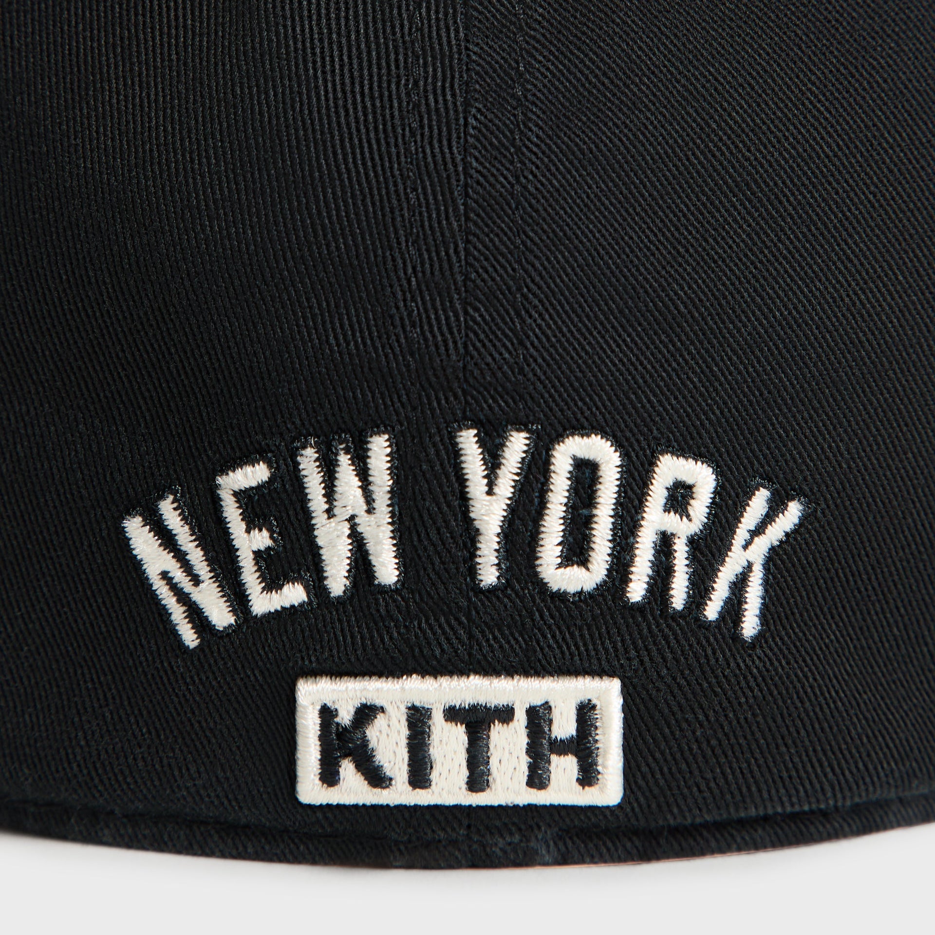 Close-up of New York arched text and Kith wordmark patch on back of Kith & '47 Yankees cap in black