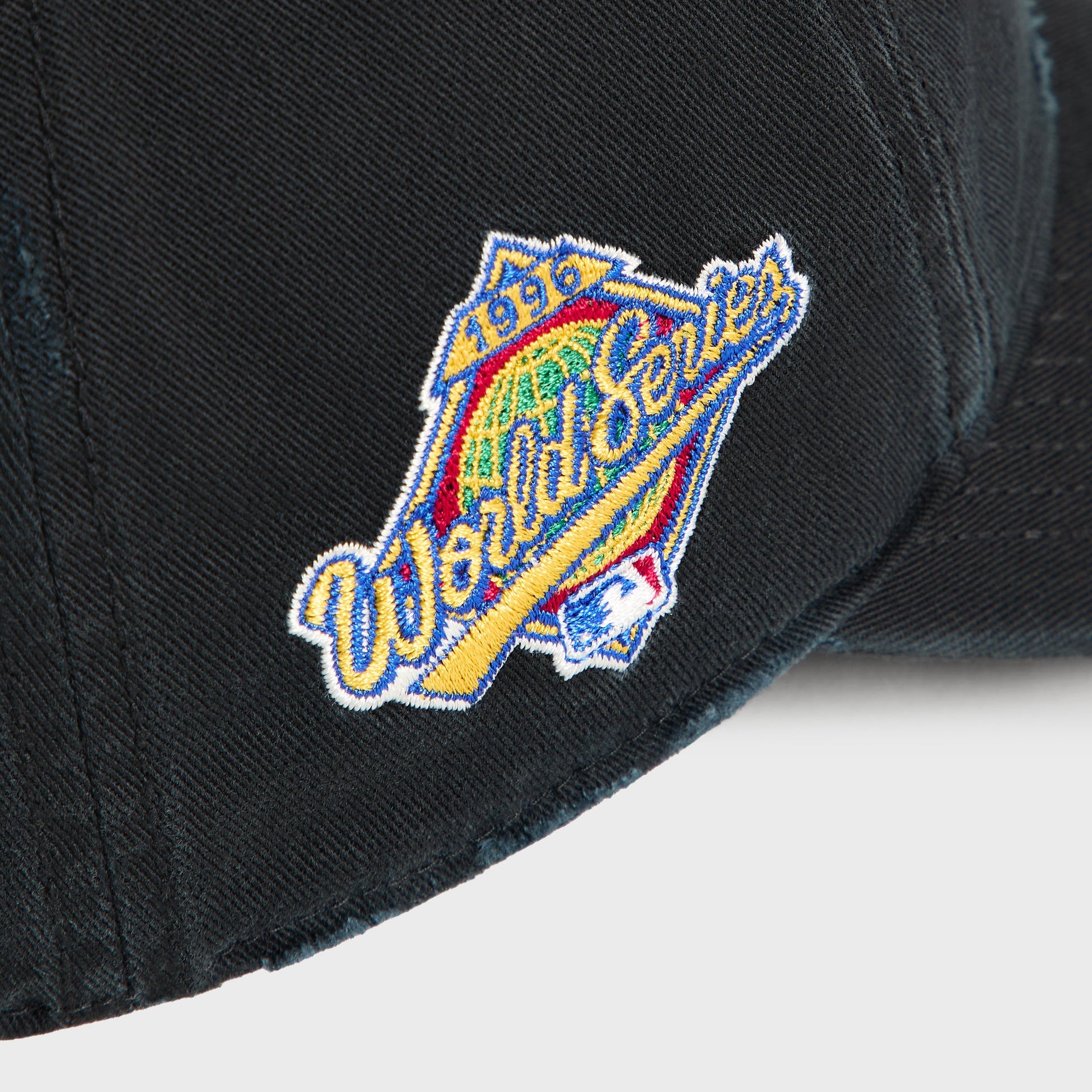 Close-up of 1999 World Series patch on side panel of Kith & '47 Yankees cap in black