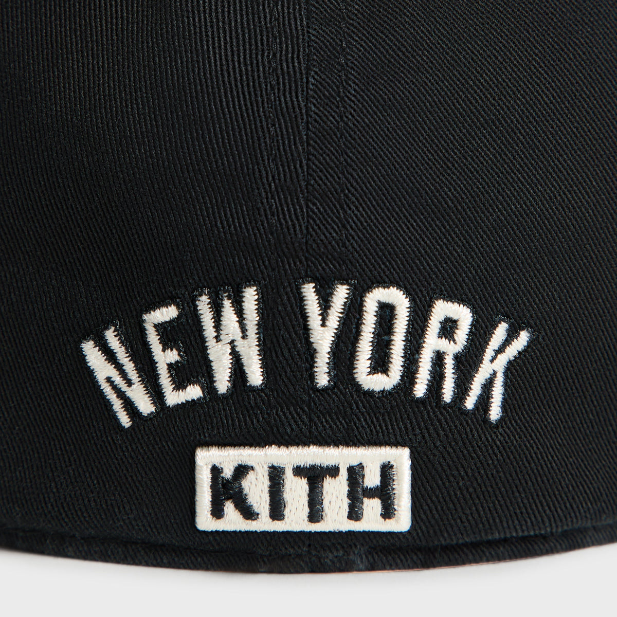 Close-up back detail of New York Kith text embroidery on Black Sun Faded Franchise LS Cap