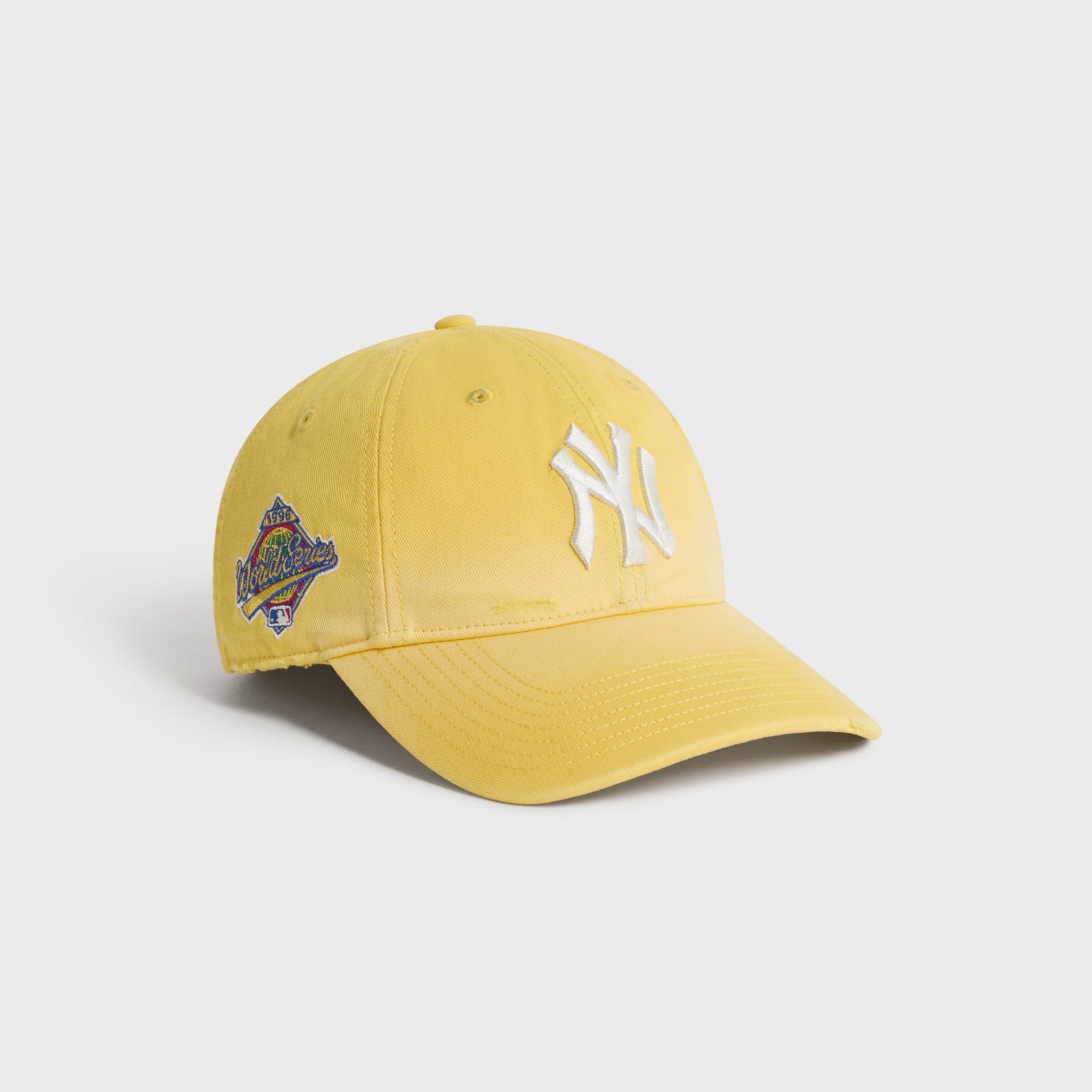 Kith & '47 Sun Faded Franchise LS Cap in Buzz, angled view showing NY logo and 1996 World Series patch