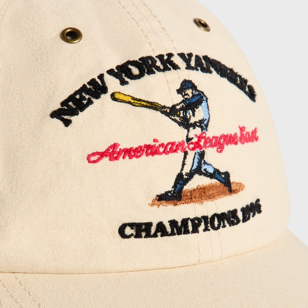 Close-up of vintage batter graphic and Champions 1996 embroidery on Sandrift Duck Canvas Visor Cap