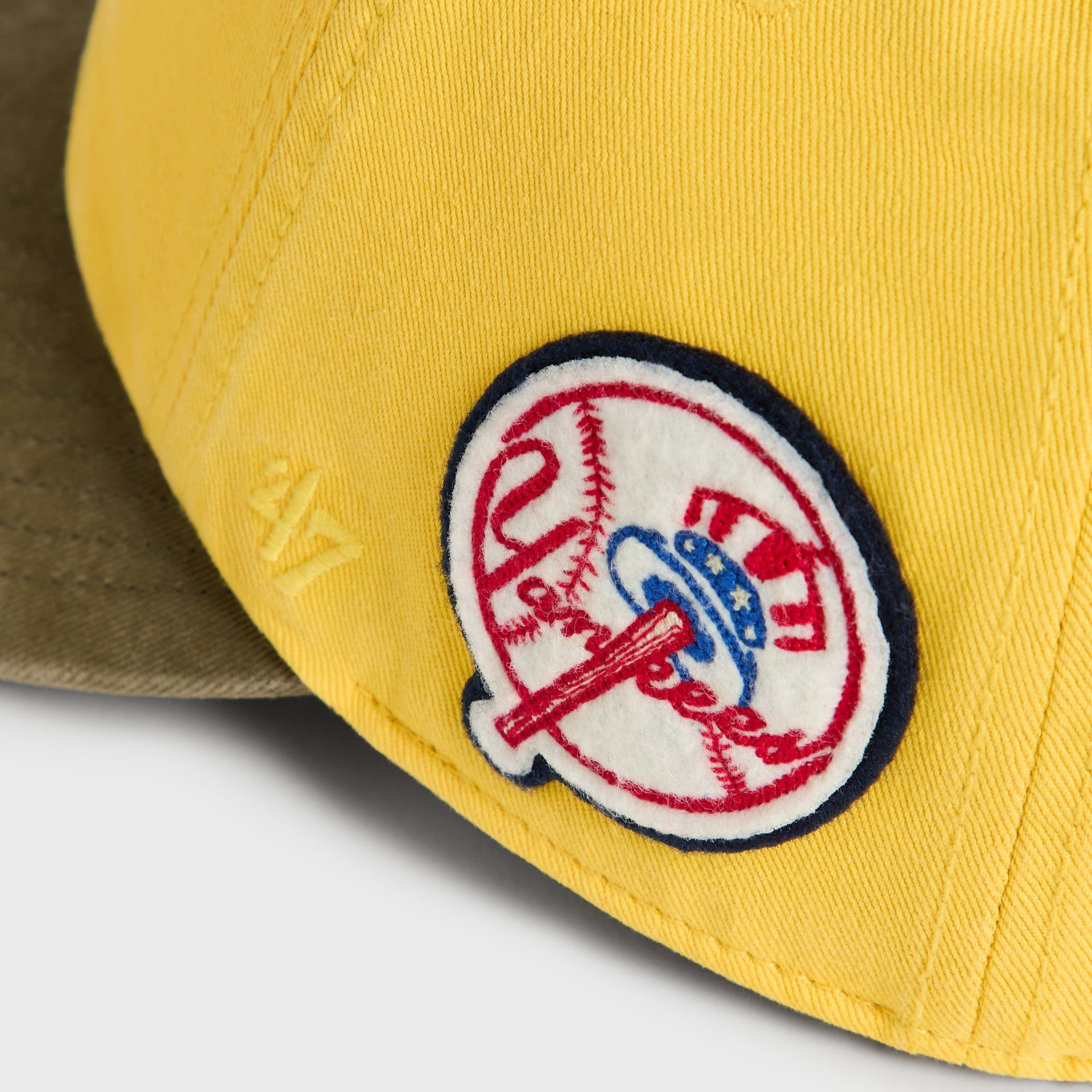 Close-up of circular vintage New York Yankees side patch on Buzz Round Visor Cap
