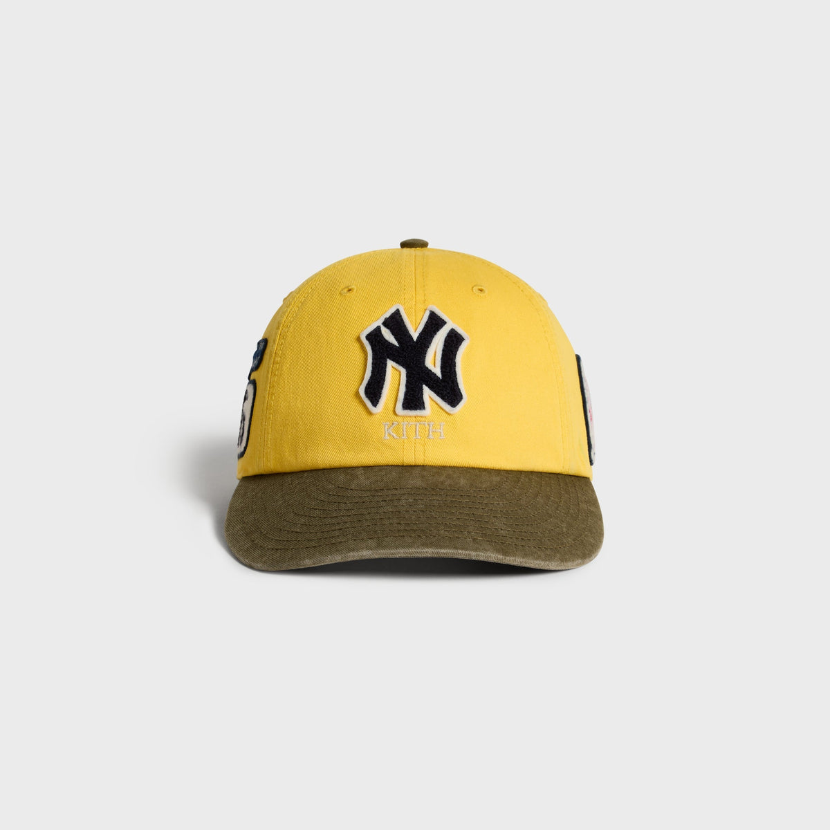 Kith & '47 Clean Up Round Visor Cap in Buzz yellow with olive visor, front view with NY chenille patch