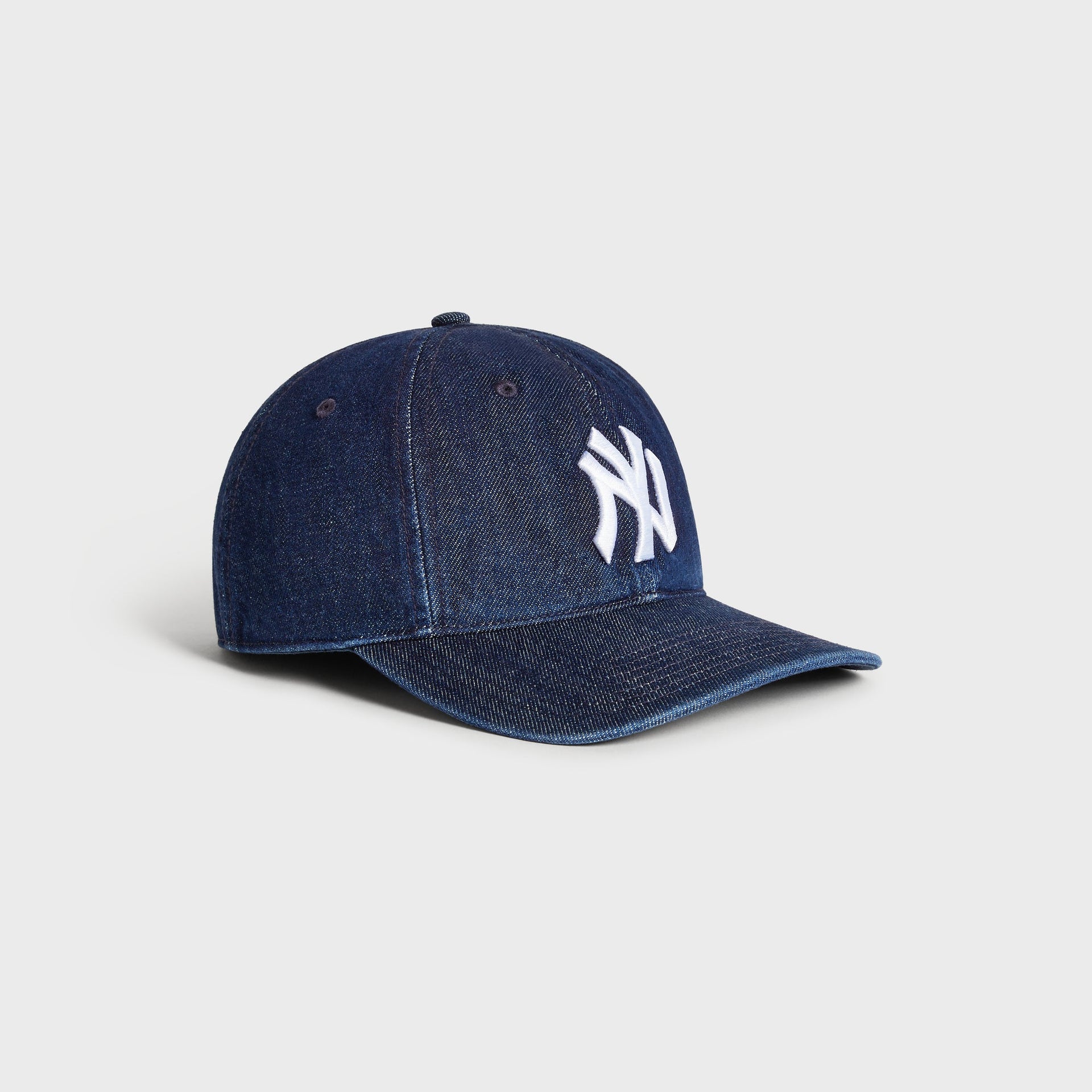 Three-quarter angled view of the Kith & '47 Yankees Denim Franchise Cap in Mystery denim wash