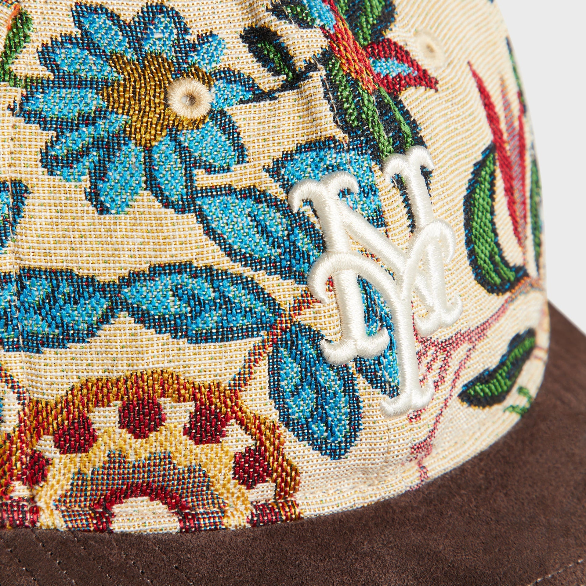 Close-up detail of embroidered NY Mets logo on the floral tapestry crown, Kith & '47 Durum cap