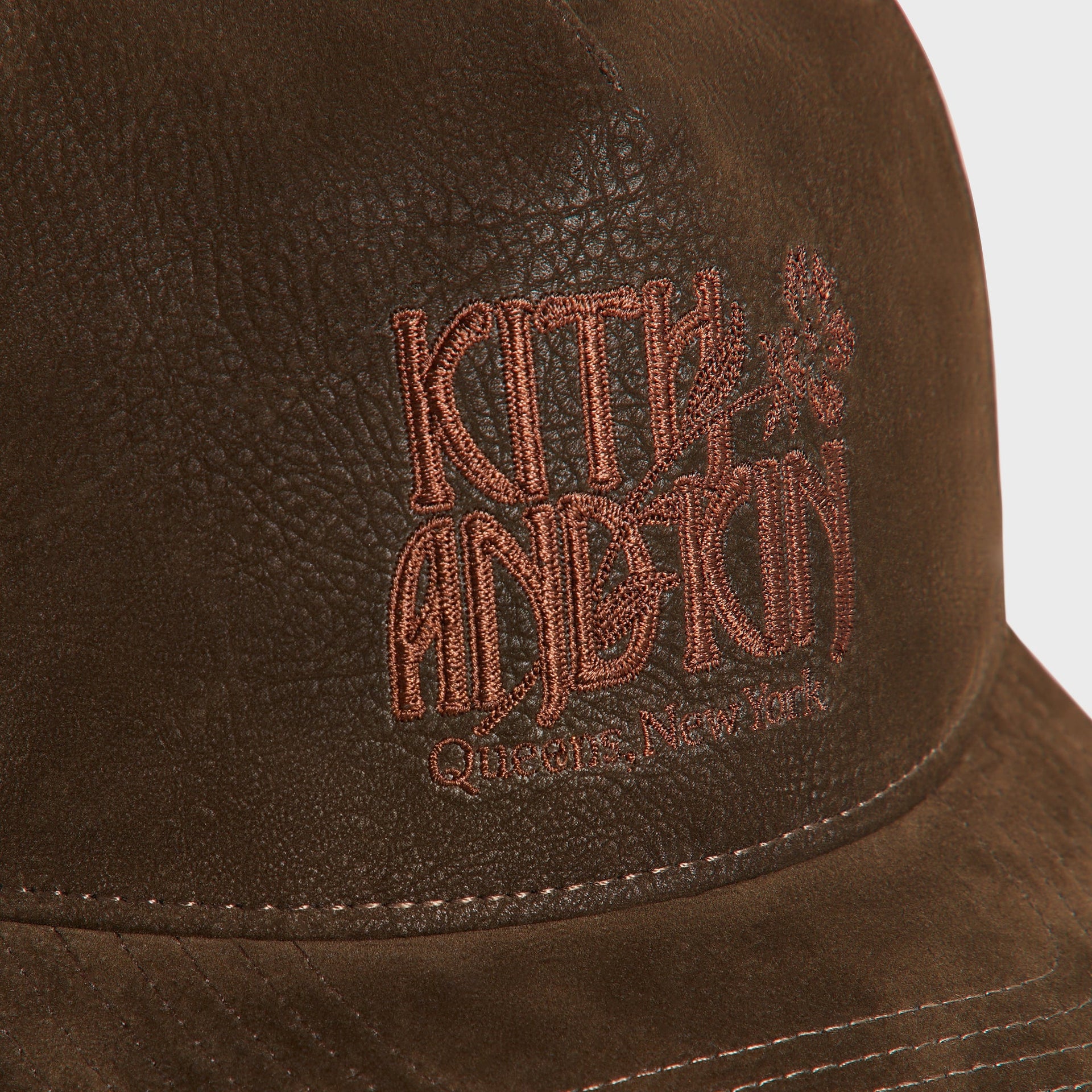 Kith Botanical Twill Bay Low Pinch Crown Cap in Clever, close-up of embroidered Kith and Kin logo with floral emblem