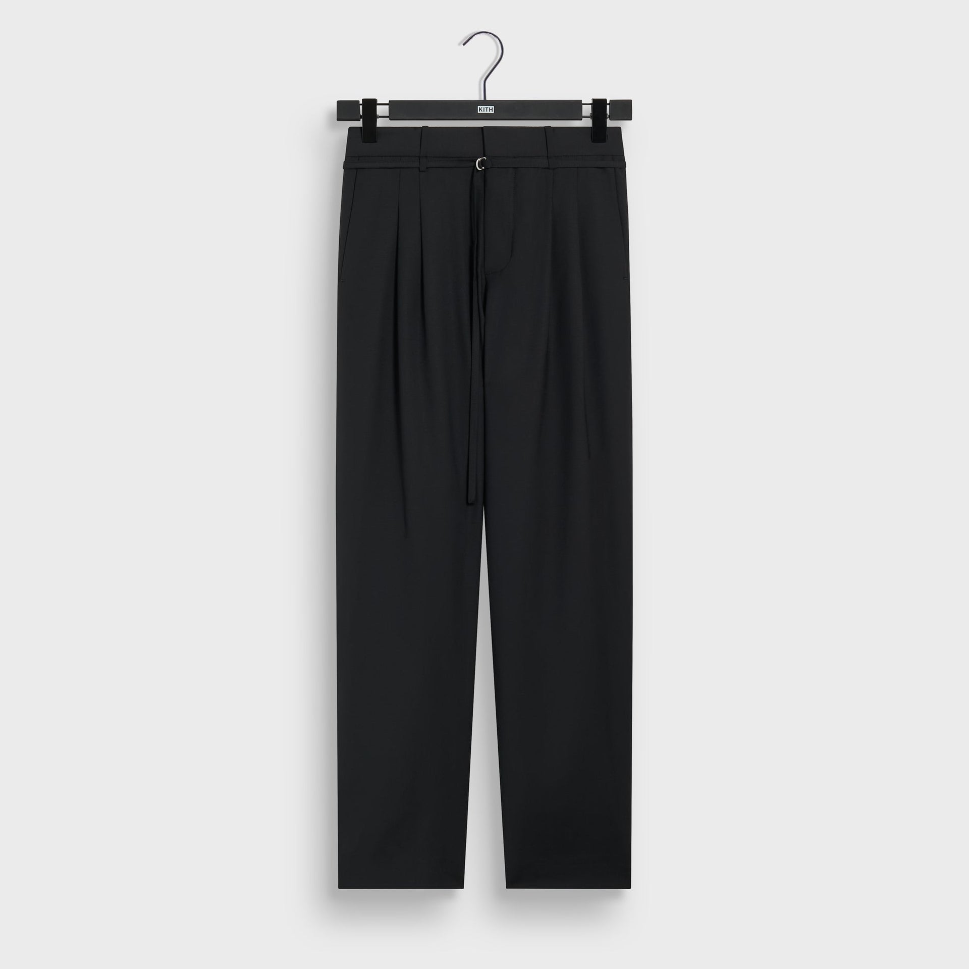 &Kin Tropical Wool Eli Pleated Trouser in black on a Kith hanger, front view with D-ring drawstring belt