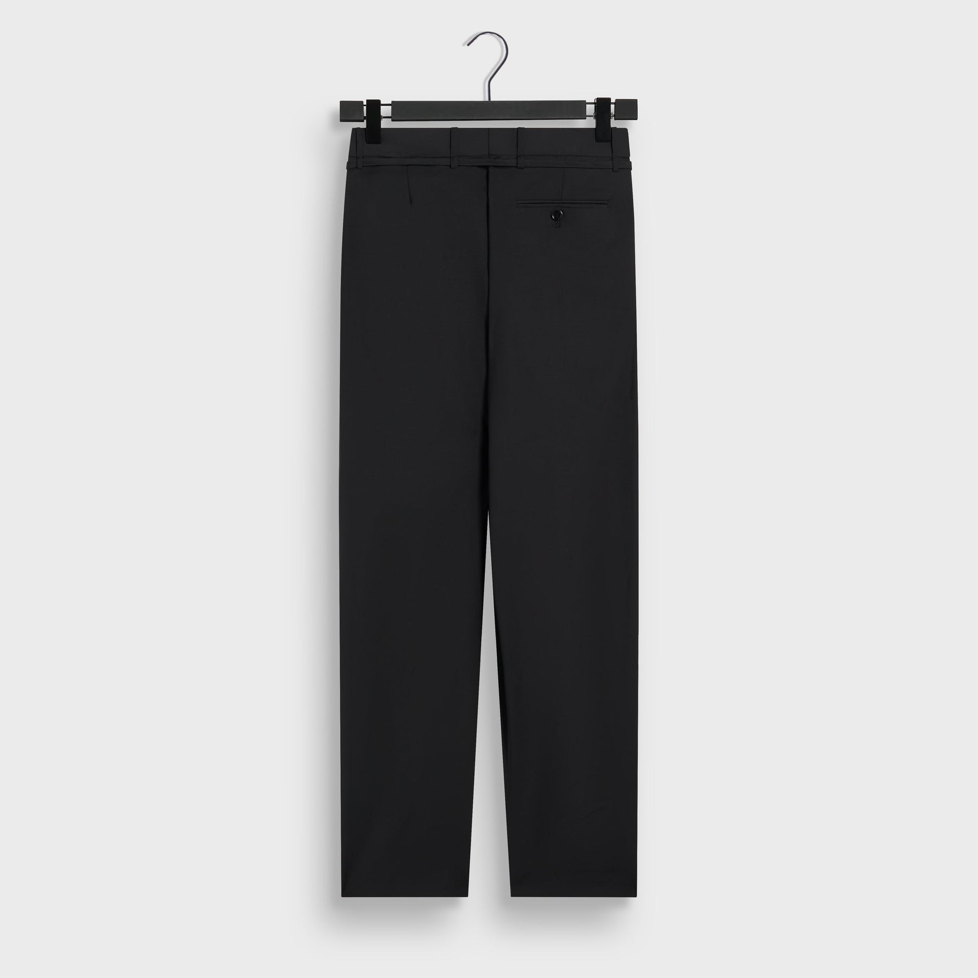 &Kin Tropical Wool Eli Pleated Trouser in black, back view on a hanger with a welt button pocket