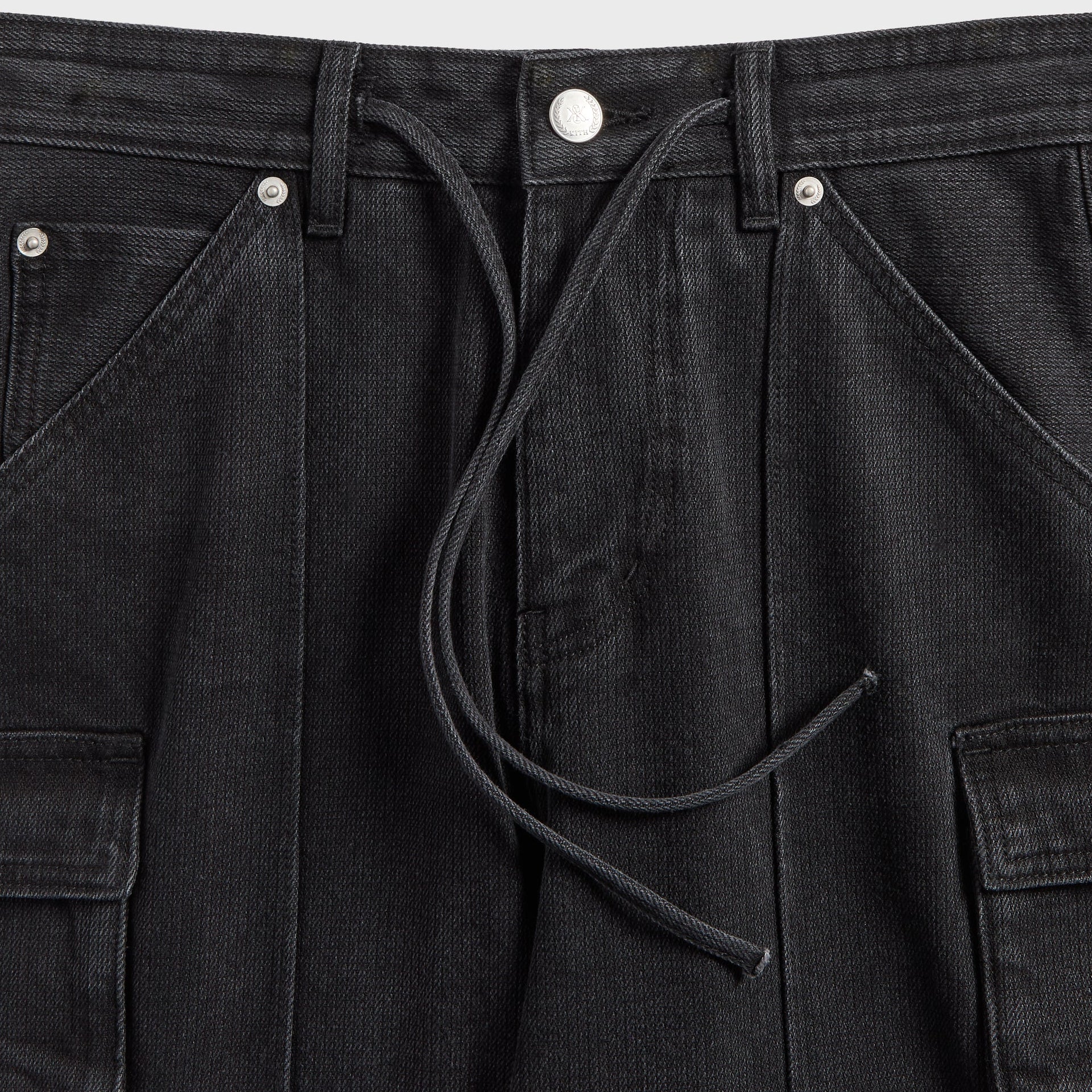 Close-up of the drawstring waist and cargo pocket on the Kith Zane cargo pant in black denim