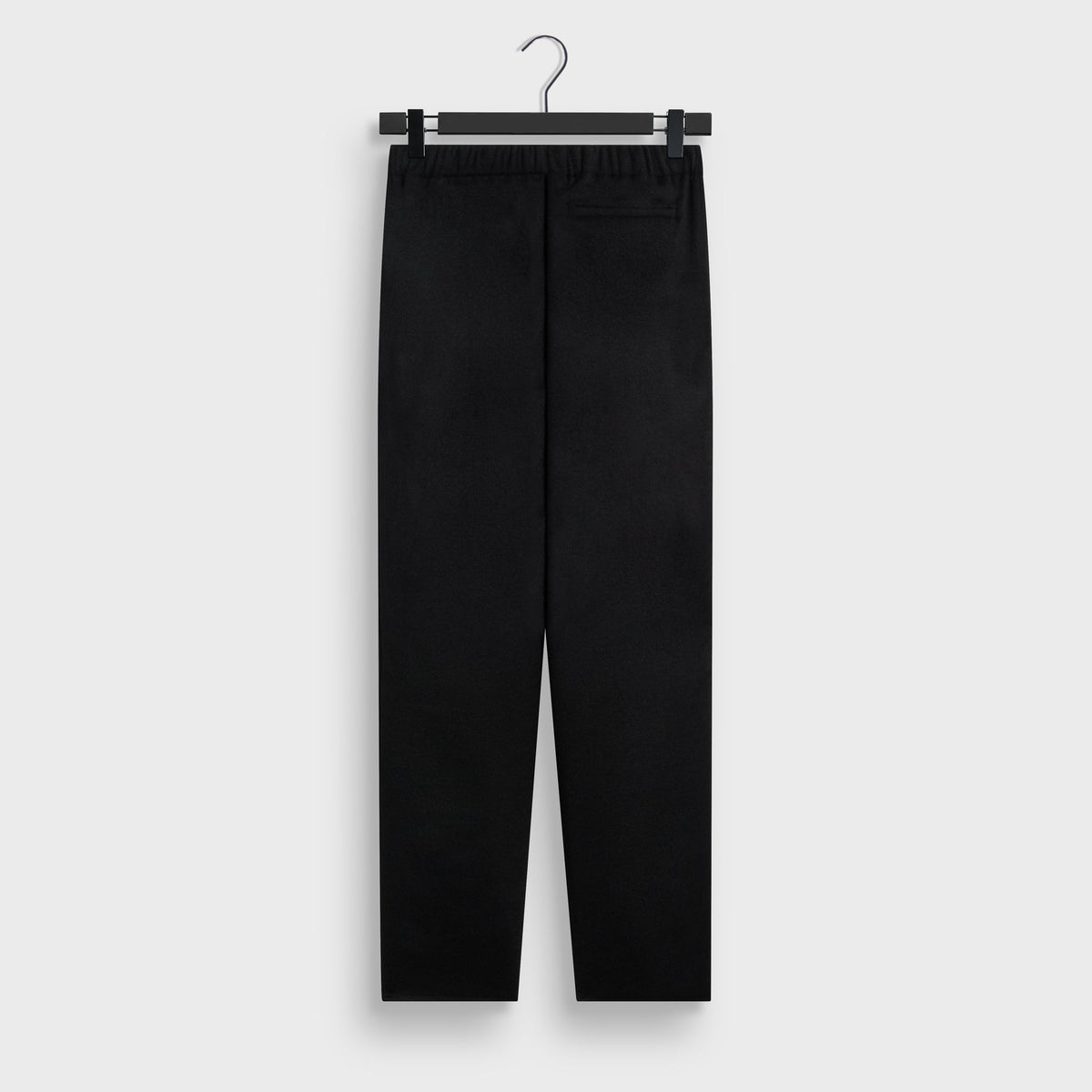 Kith Double-Face Wool Avi Pant in black, back view on hanger with elastic waistband and single welt back pocket