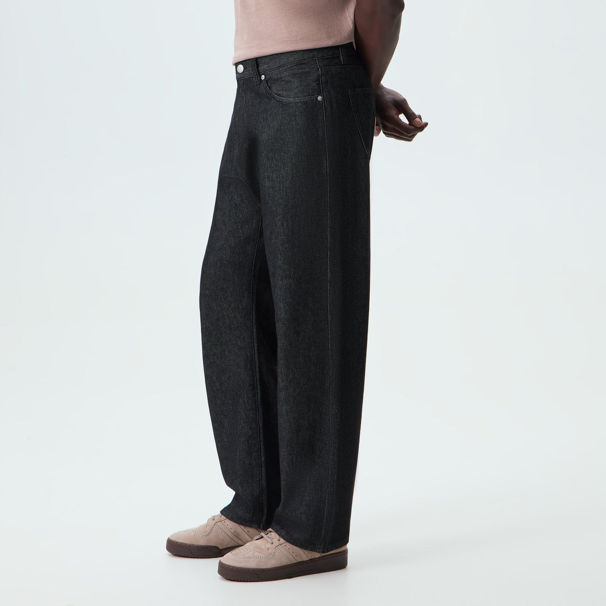 Man wearing washed black Kith Denim Webster Chill wide-leg jeans, side view