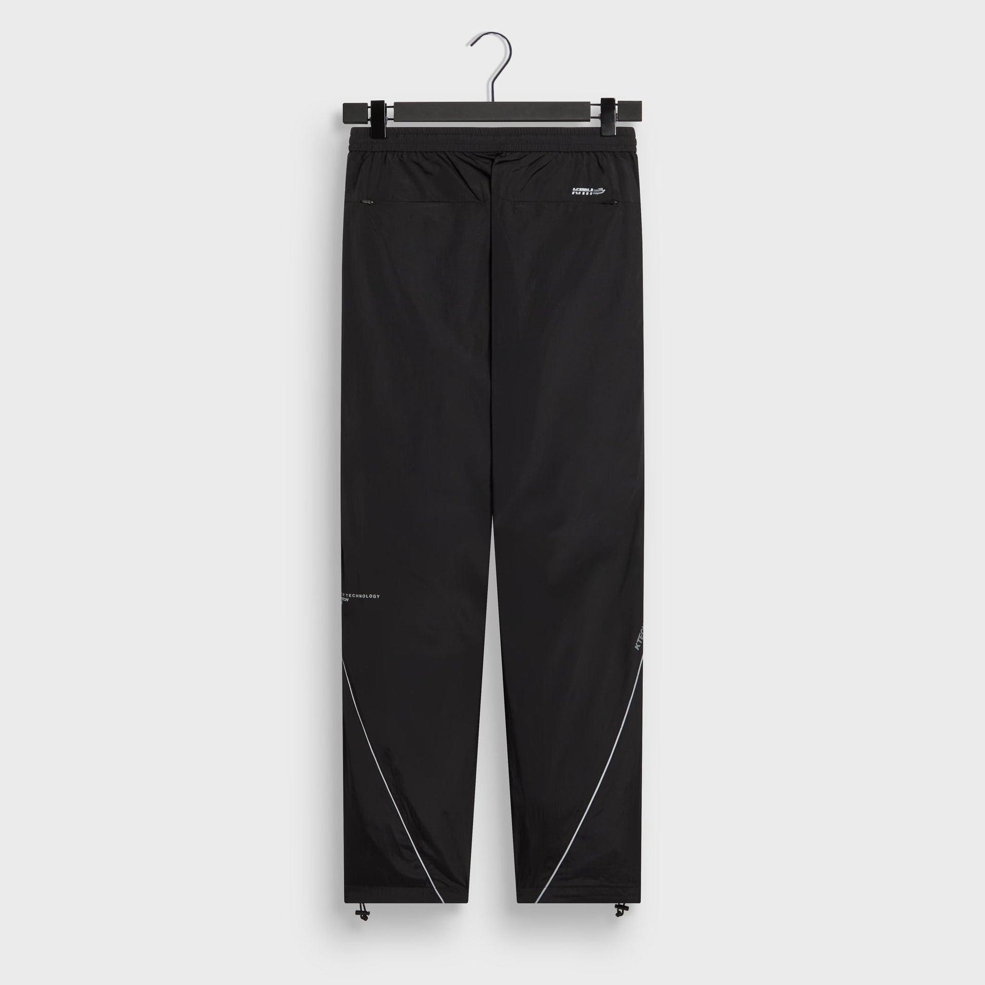 Kith Seamed Nylon Bolt pant in black with reflective seam detail, back flat lay
