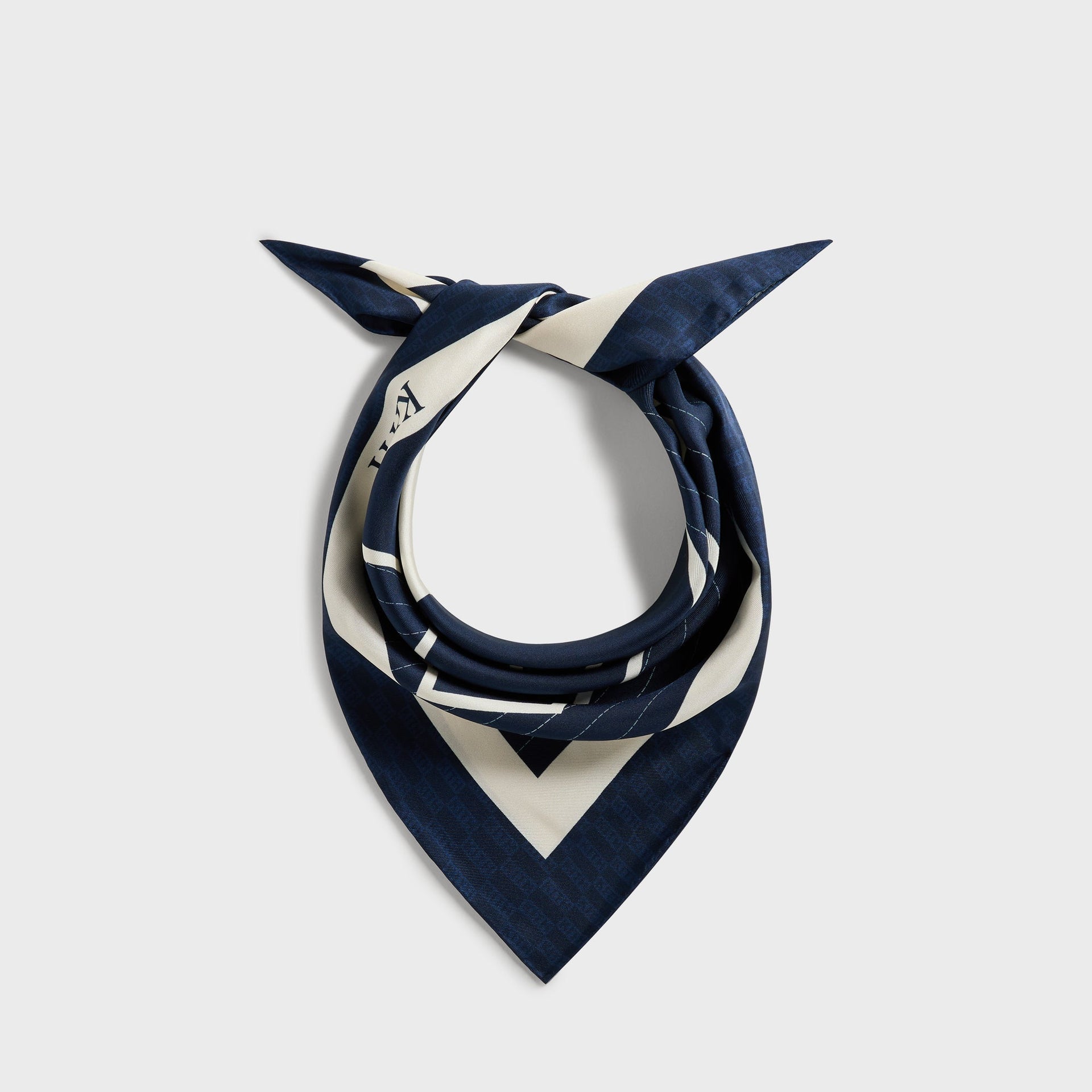 Kith for the New York Yankees silk bandana in navy and cream, knotted and styled as a neck accessory