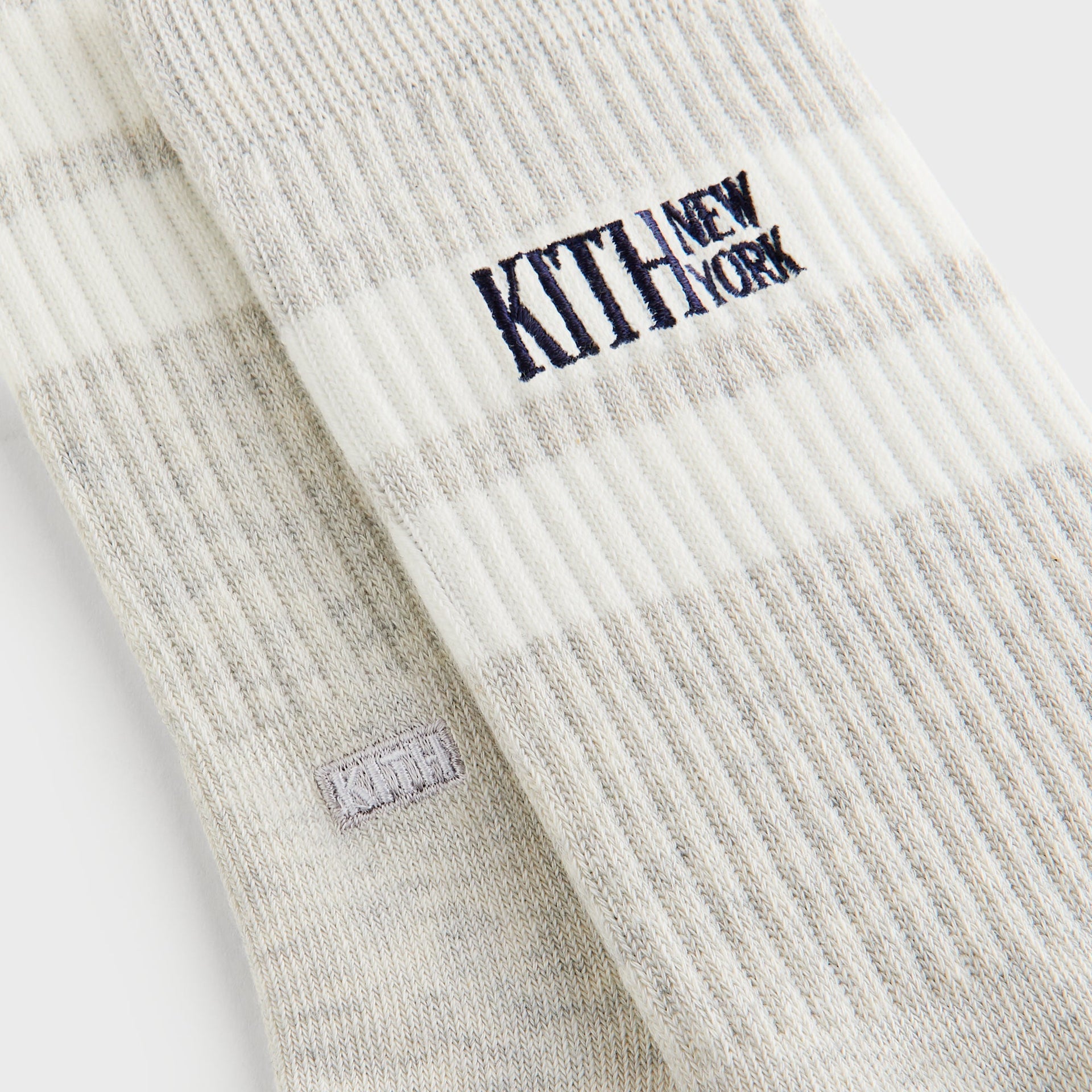Close-up of the Kith New York embroidered logo and ribbed knit stripe on the cuff of the Kith Calf Stripe Socks in Heather Grey.