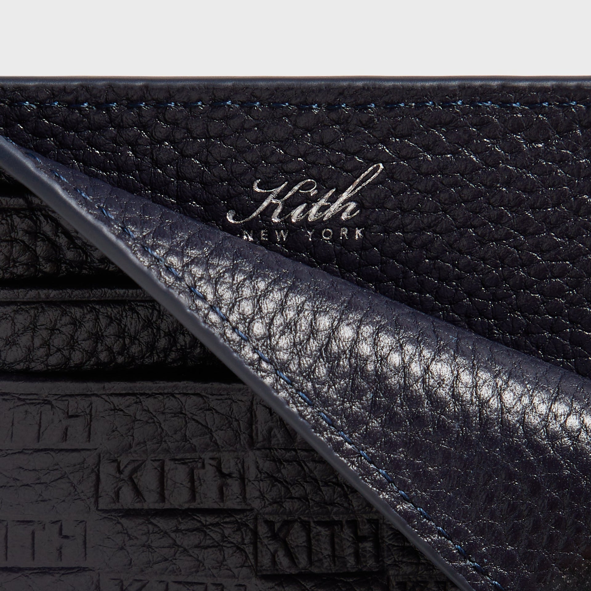 Kith Monogram Tumbled Leather Card Holder in Ink, macro detail of foil-stamped Kith New York logo