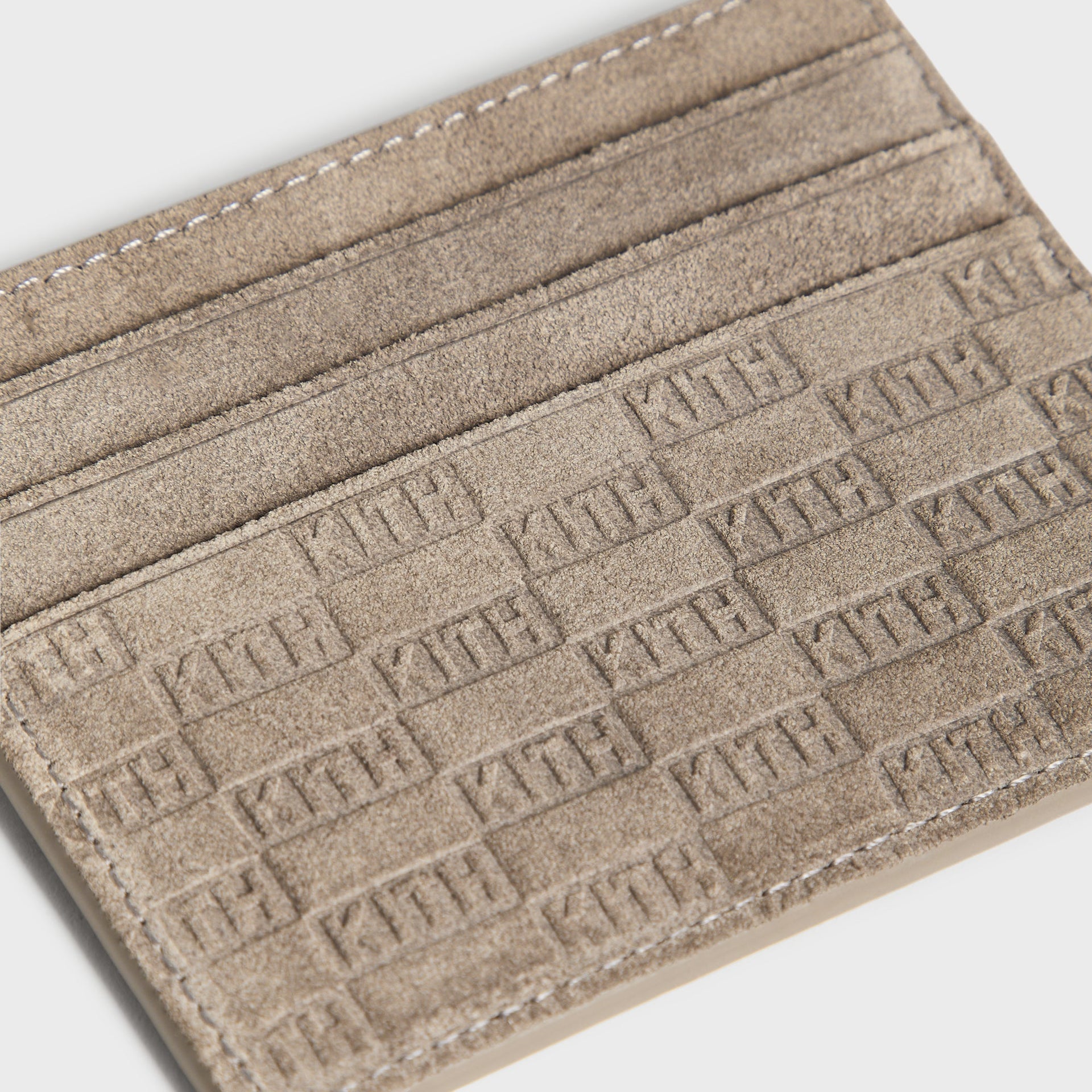 Kith Monogram Suede Cardholder in Java, close-up of suede interior card slots with embossed KITH monogram pattern
