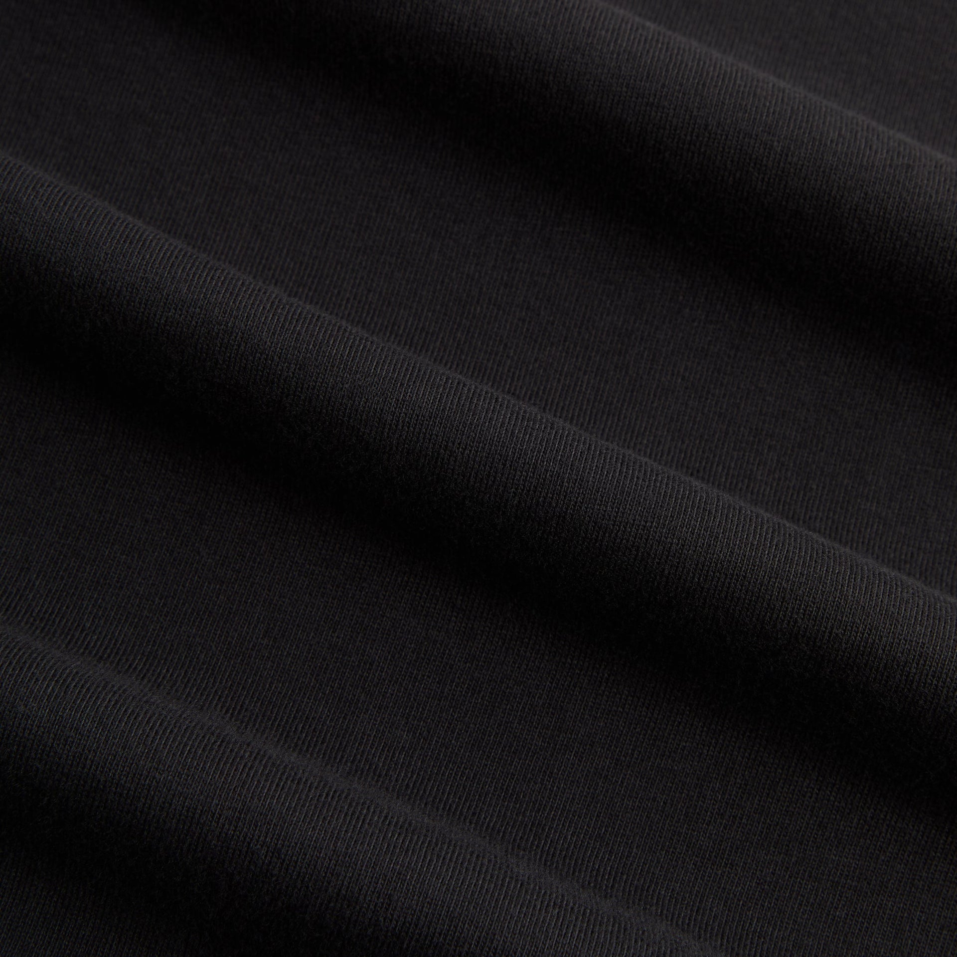 Kith for Cinelli Ciclismo Tee close-up of soft black cotton fabric texture and weave