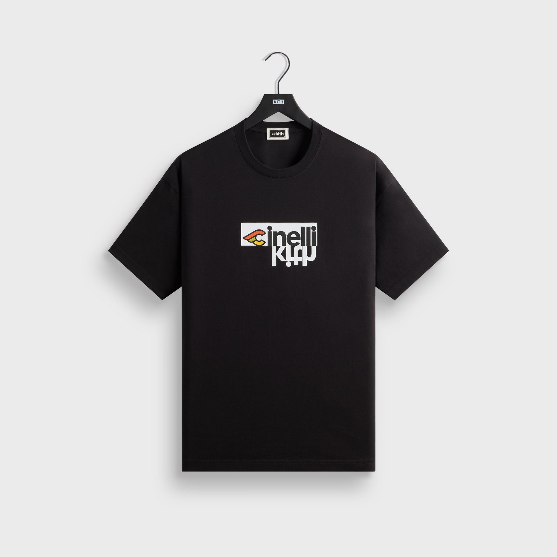 Kith for Cinelli Upside Down Tee in black, front view on hanger with winged Cinelli logo and upside-down Kith chest graphic.