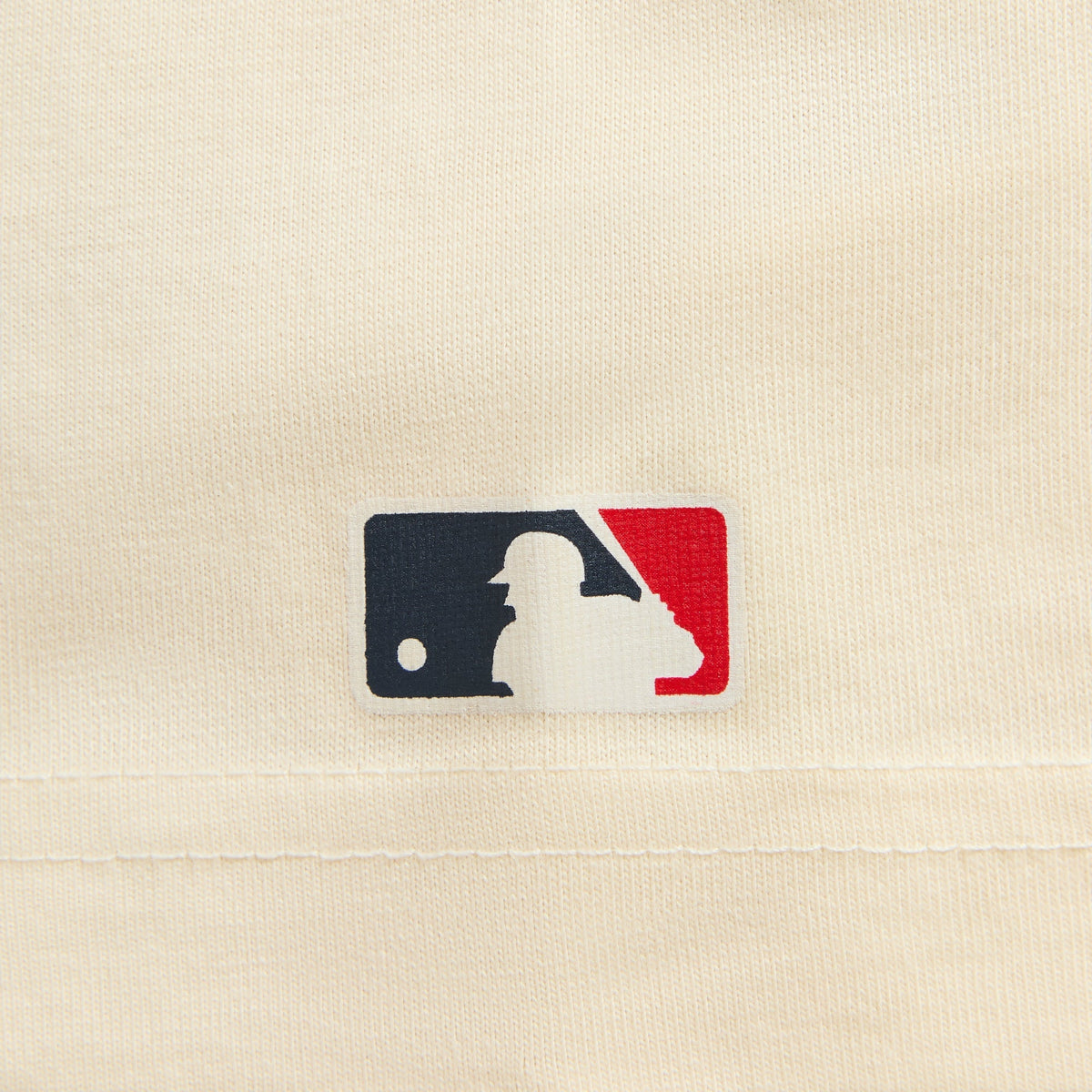 Close-up of MLB logo patch on cream Kith for New York Yankees script tee