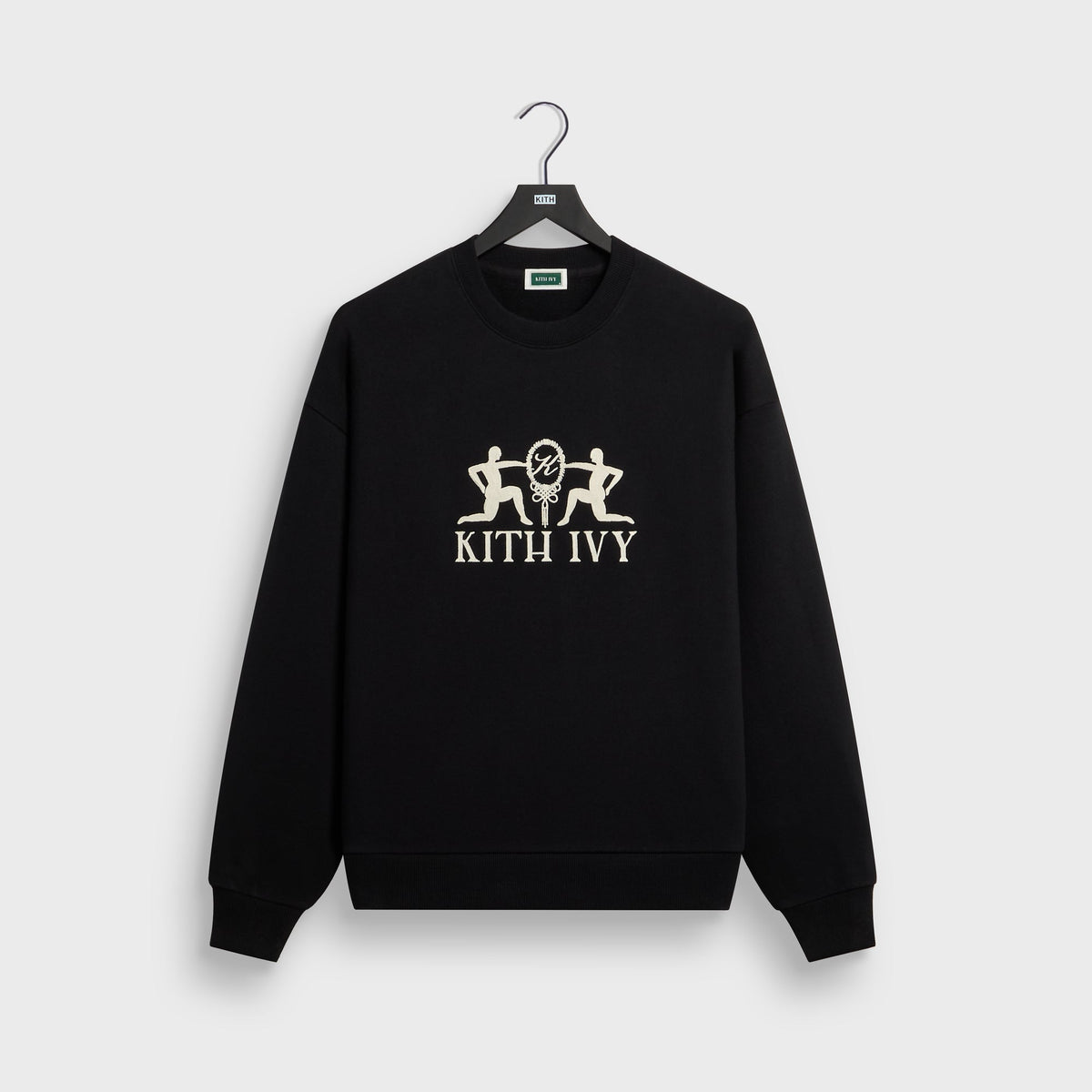 Kith Ivy Emblem Vintage Crewneck in black, front flat lay on hanger with cream embroidered kneeling figures and KITH IVY