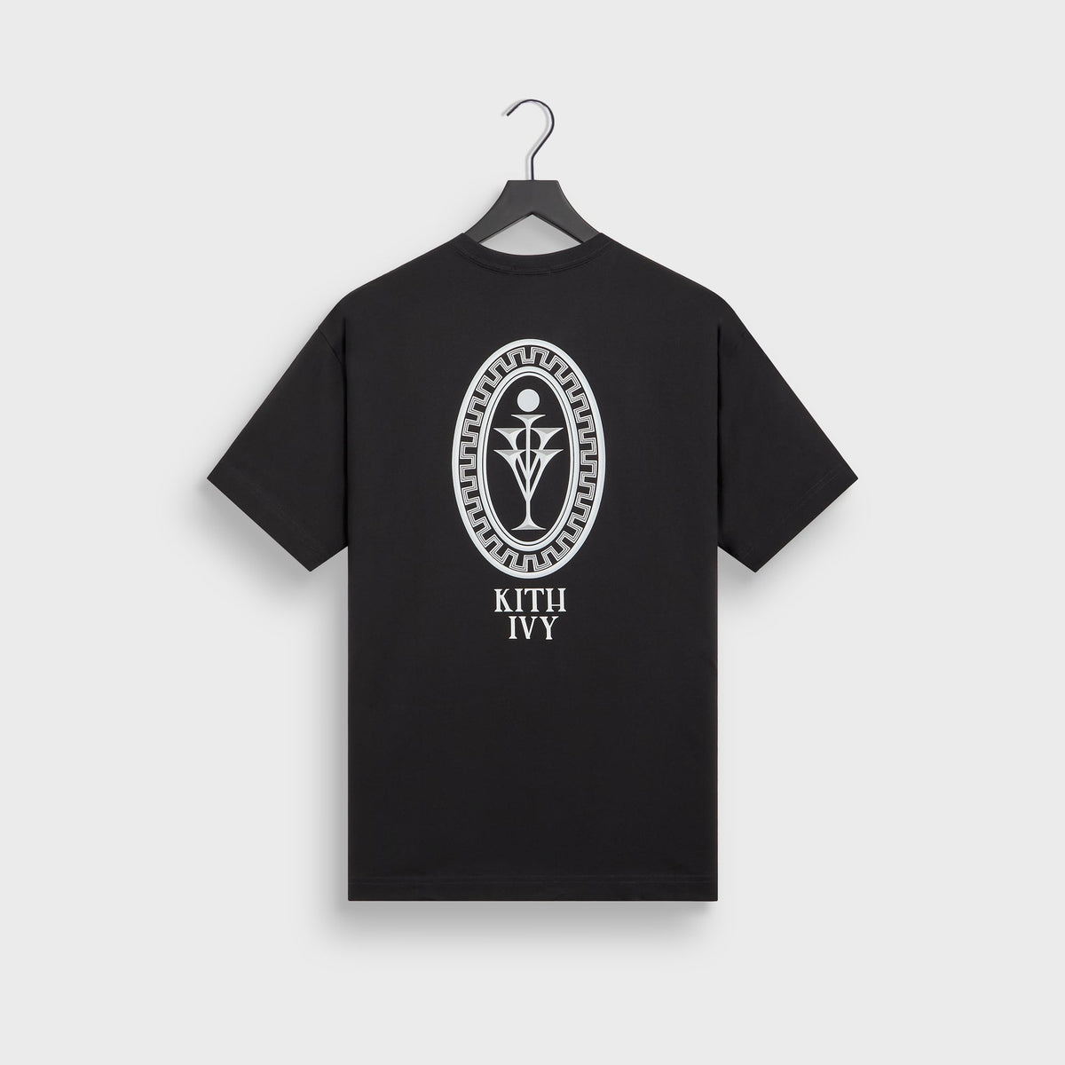 Kith Ivy for Cafe Mogador Pocket Tee in black on hanger, back view with large oval Greek-key emblem and KITH IVY