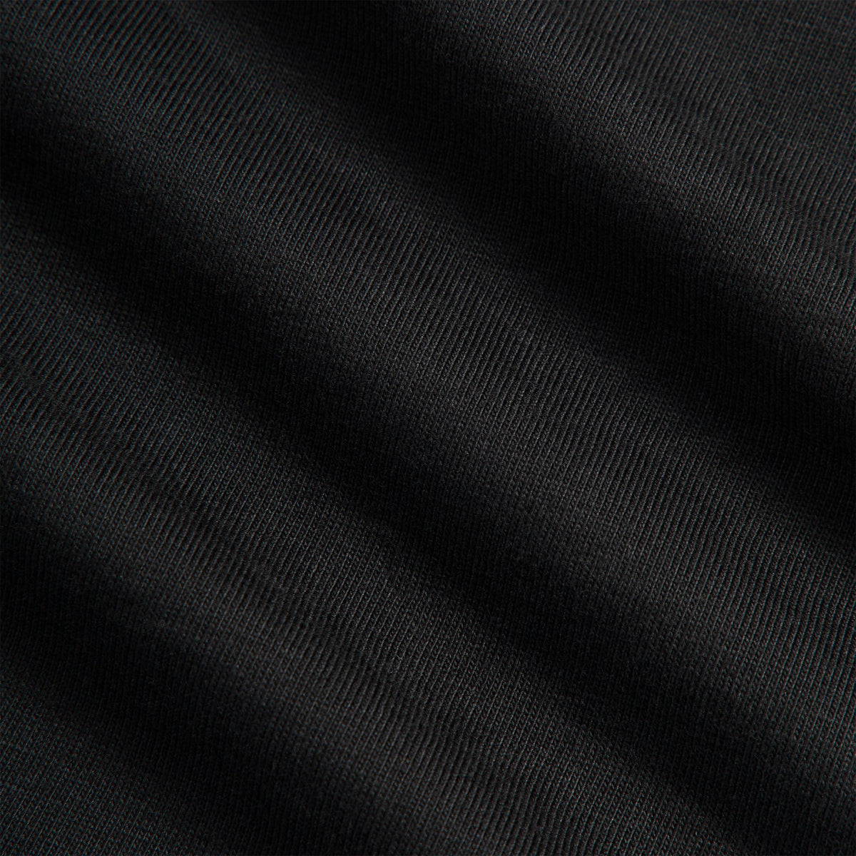 Close-up of black cotton jersey fabric texture on Kith Ivy for Cafe Mogador Pocket Tee