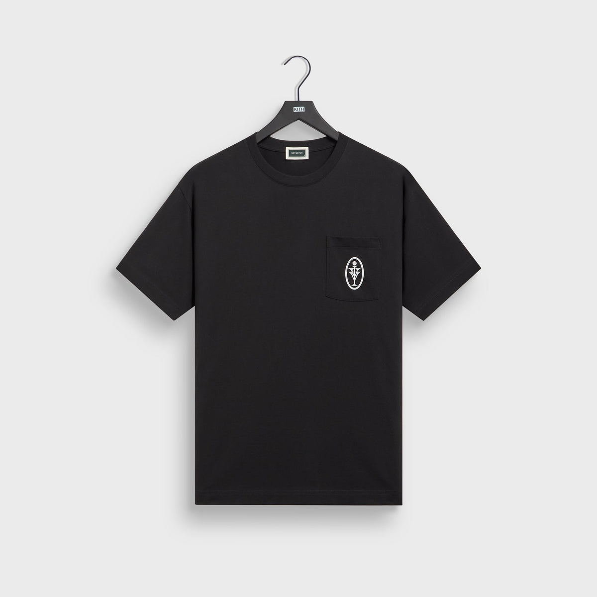 Kith Ivy for Cafe Mogador Pocket Tee in black on hanger, front view with small oval emblem on chest pocket