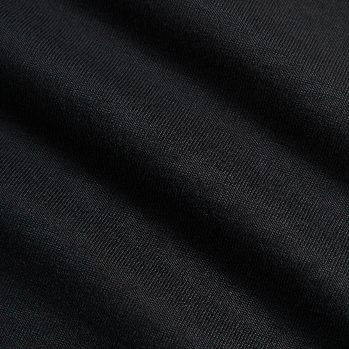 Close-up of black cotton jersey fabric texture on Kith Ivy Tee